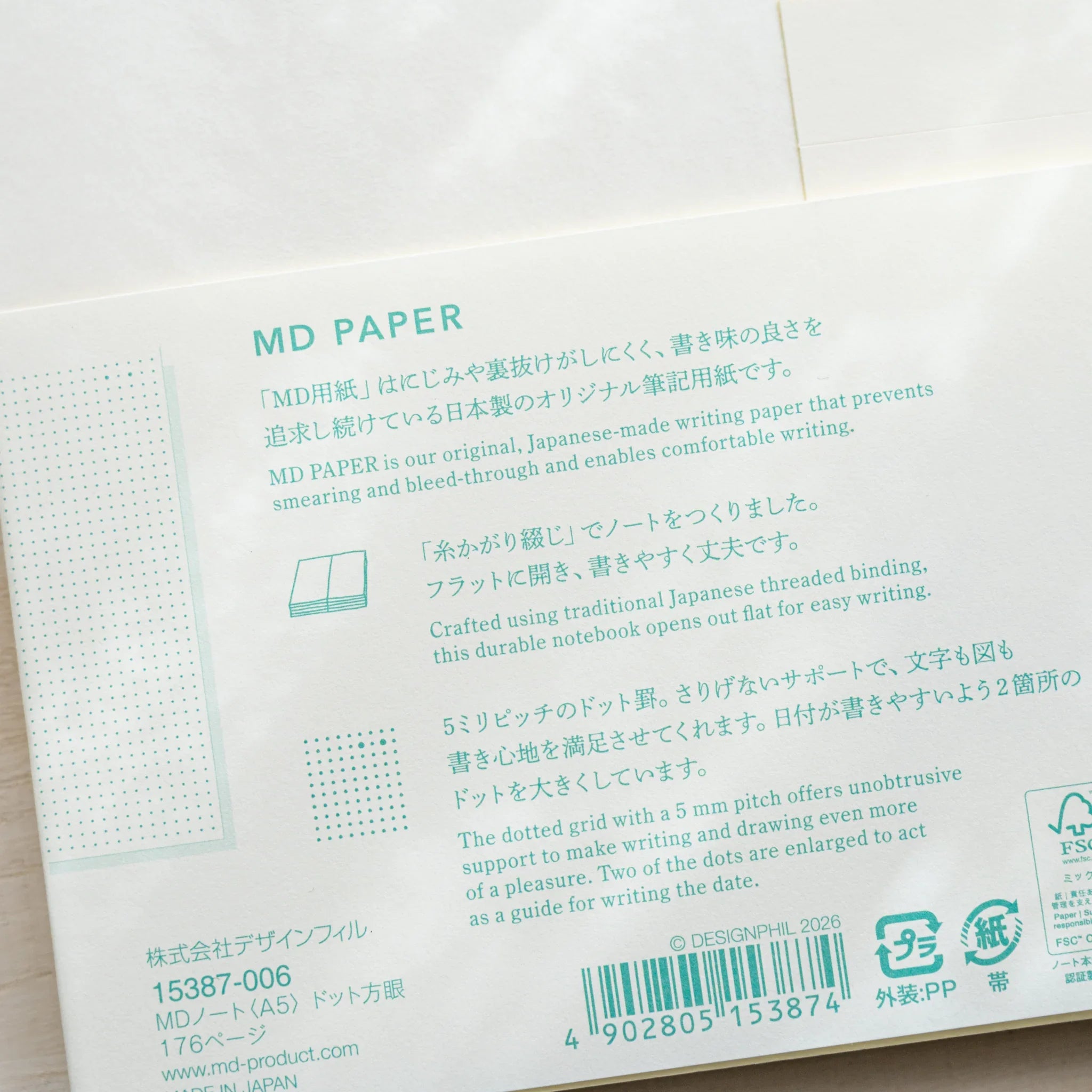 Close-up of Midori MD Notebook A5 Dot Grid belly band with MD Paper description, dot grid sample, and DESiGNPHiL product info