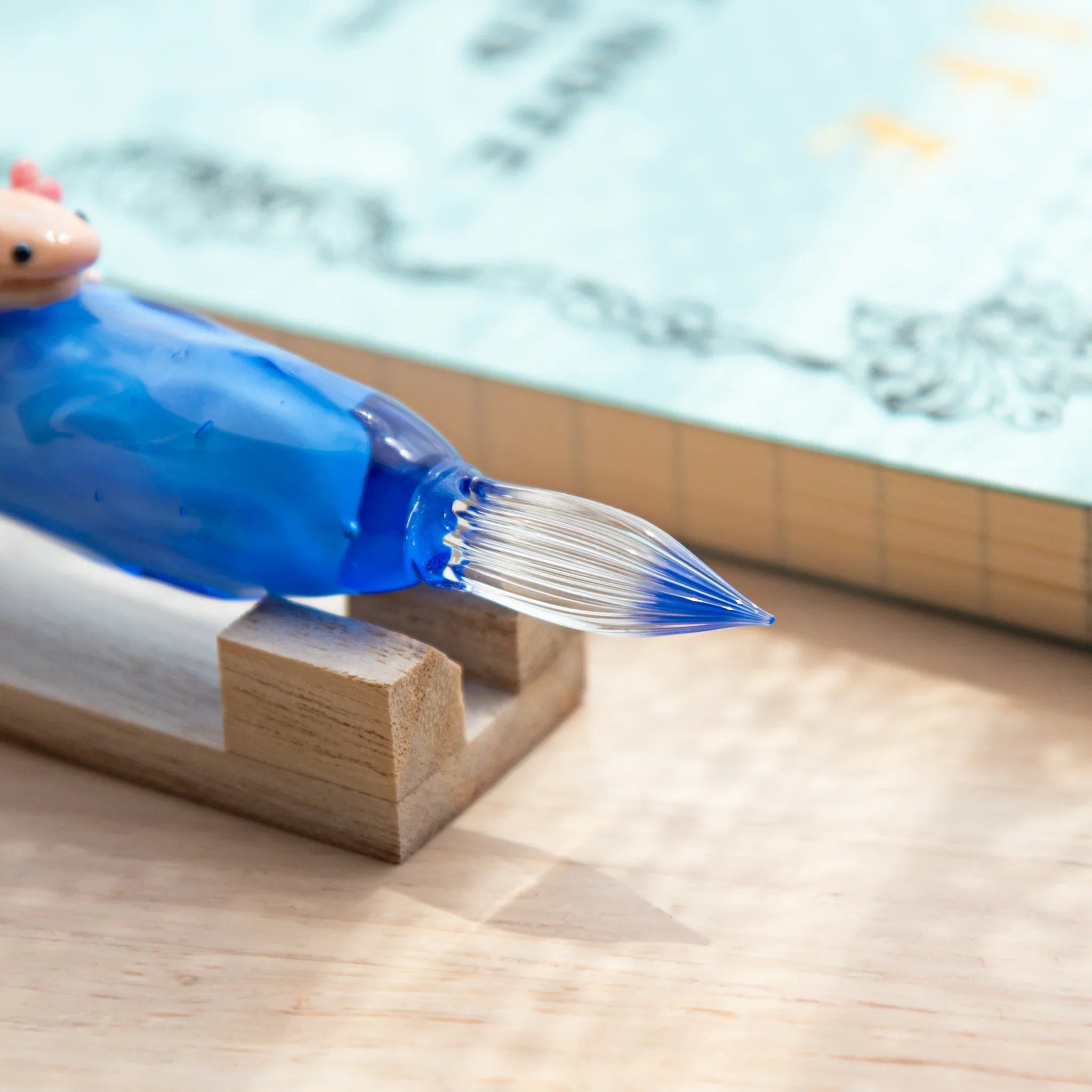 Cute axolotl glass dip pen combining whimsical character with colored glass ink vial design with unique