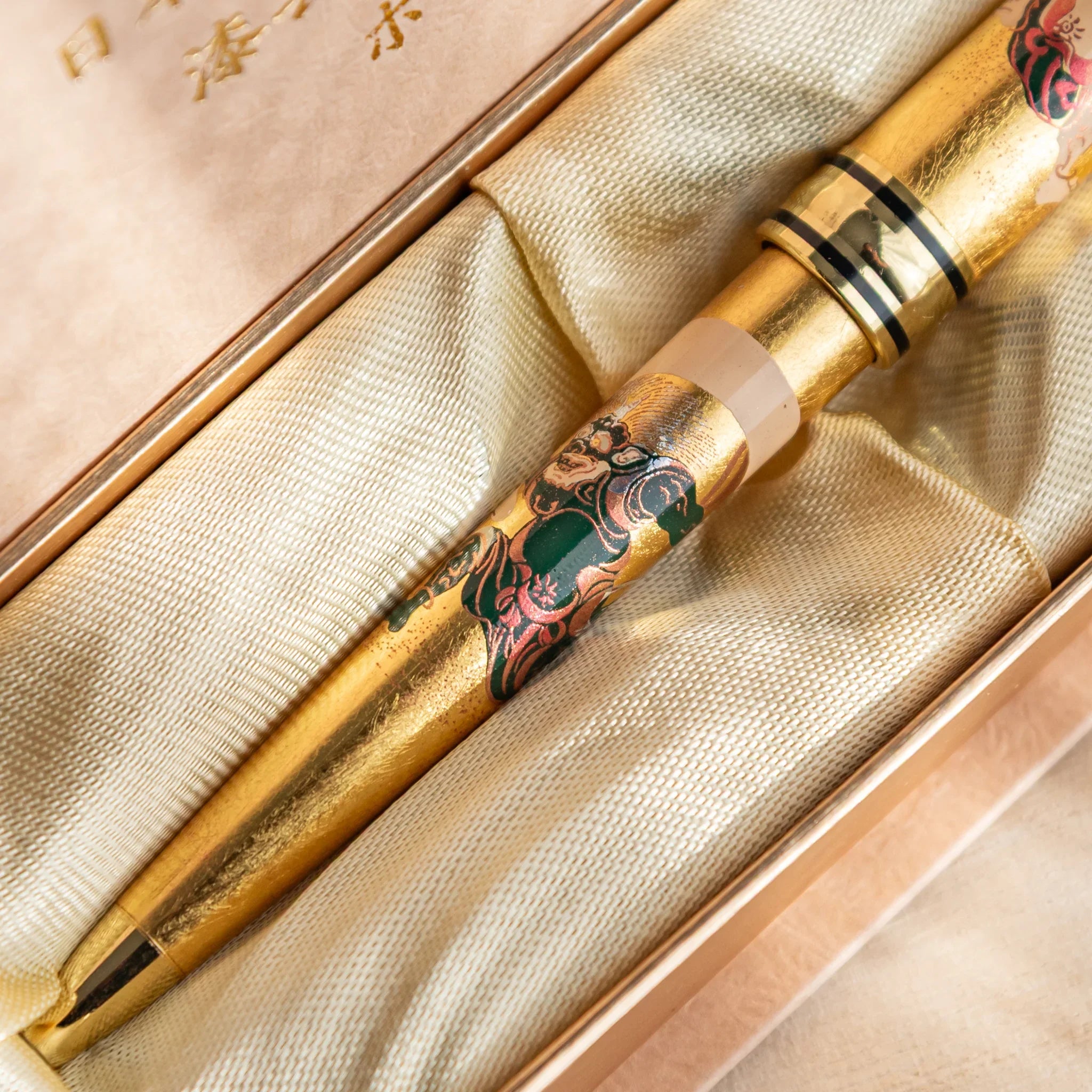 Retractable ballpoint featuring gold leaf work and traditional Japanese motif design shown in composition