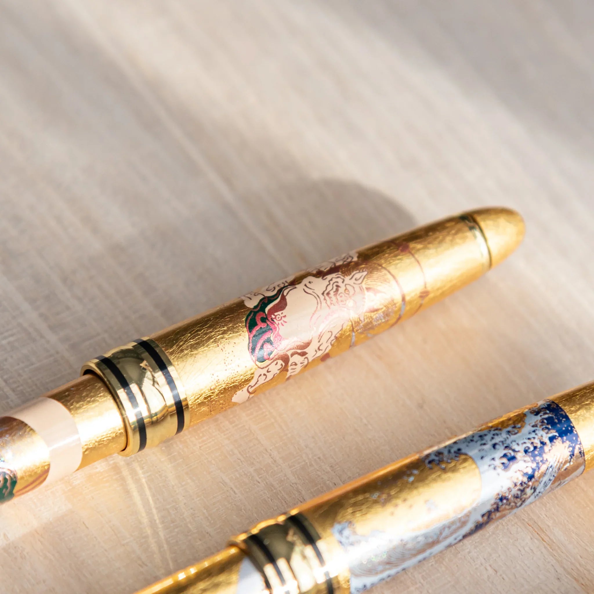 Thunder and Wind gods pen with extended ballpoint writing tip and gold trim visible displayed clearly