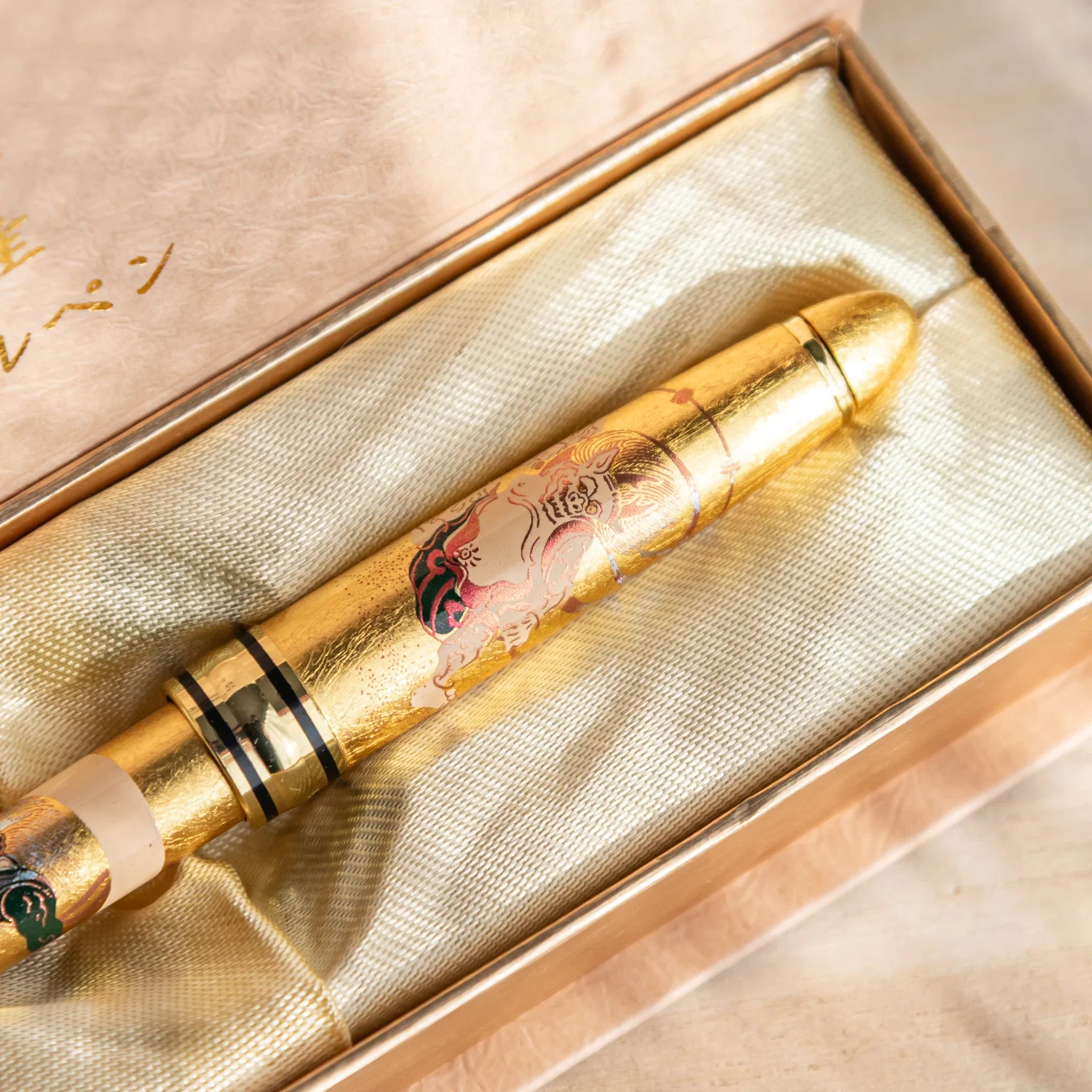 Gold Leaf Gods ballpoint pen at angle displaying full decorative pattern and design displayed clearly