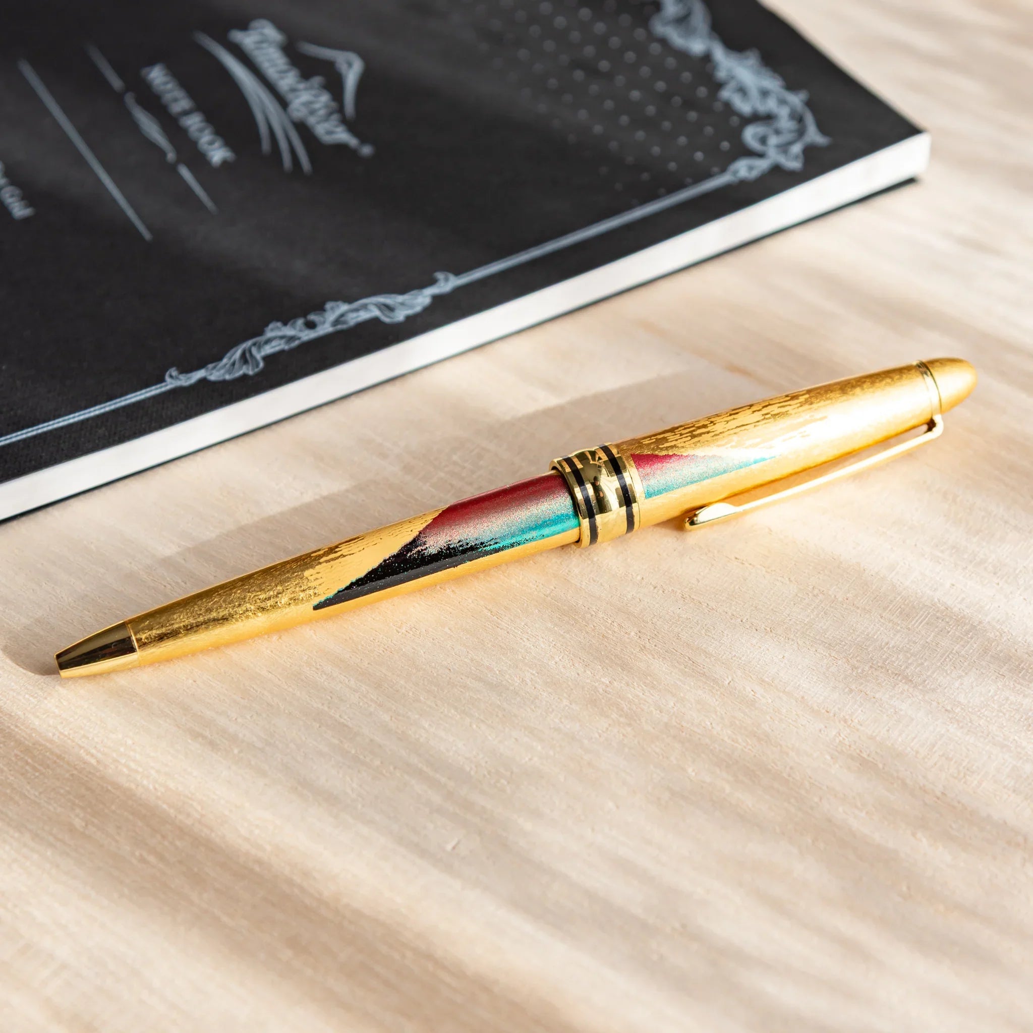 Ballpoint pen featuring Mt. Fuji landscape with gold leaf highlights on barrel displayed clearly composition