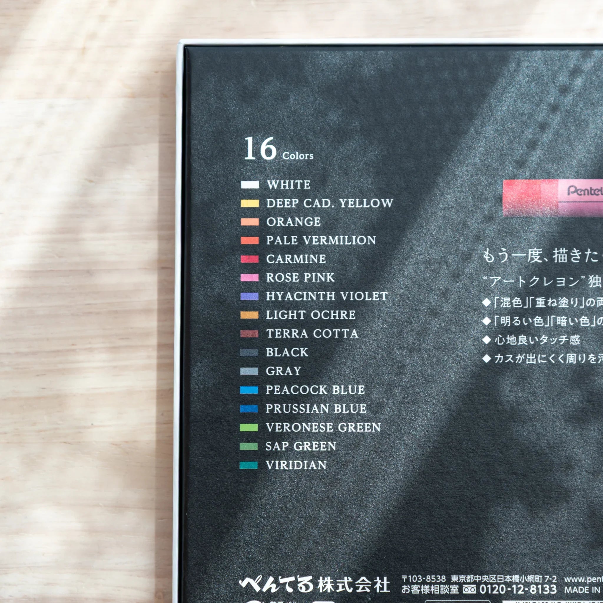 Close-up of Pentel Art Crayon 16 Colors box back panel listing all 16 color names with swatches from White to Viridian