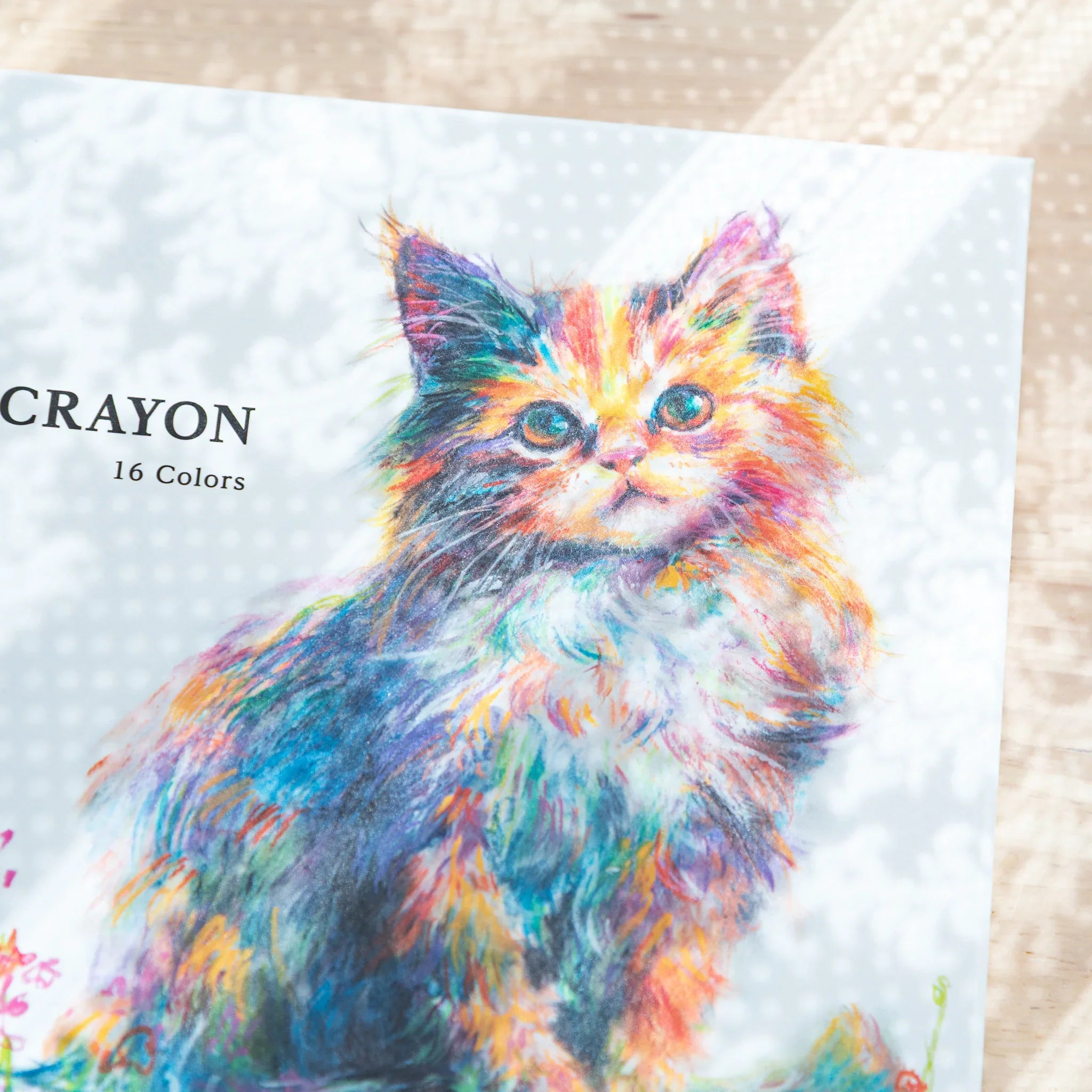 Pentel ART CRAYON 16 Colors box front close-up showing colorful kitten illustration on light dotted background