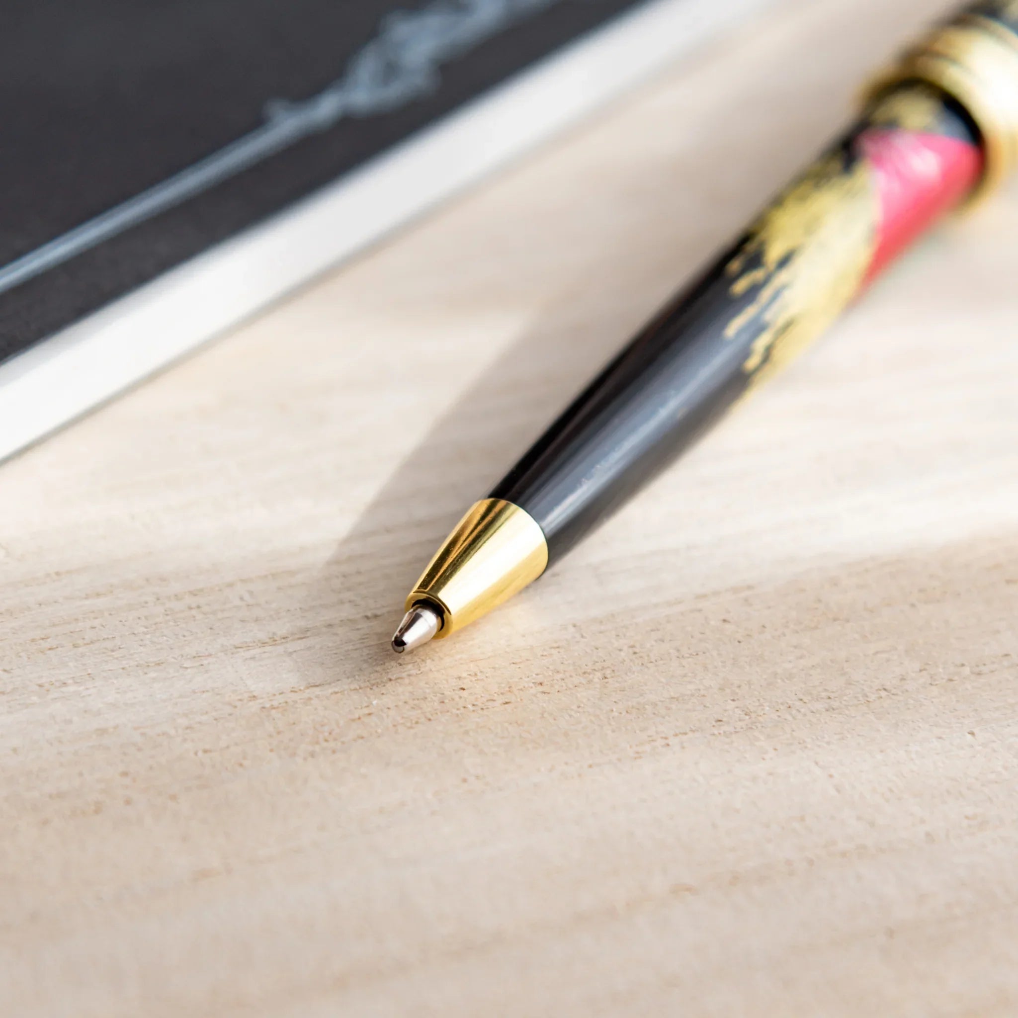 Red Mt.Fuji Yamanaka Retractable Ballpoint Pen, lifestyle arrangement showing use providing full visual representation and pr