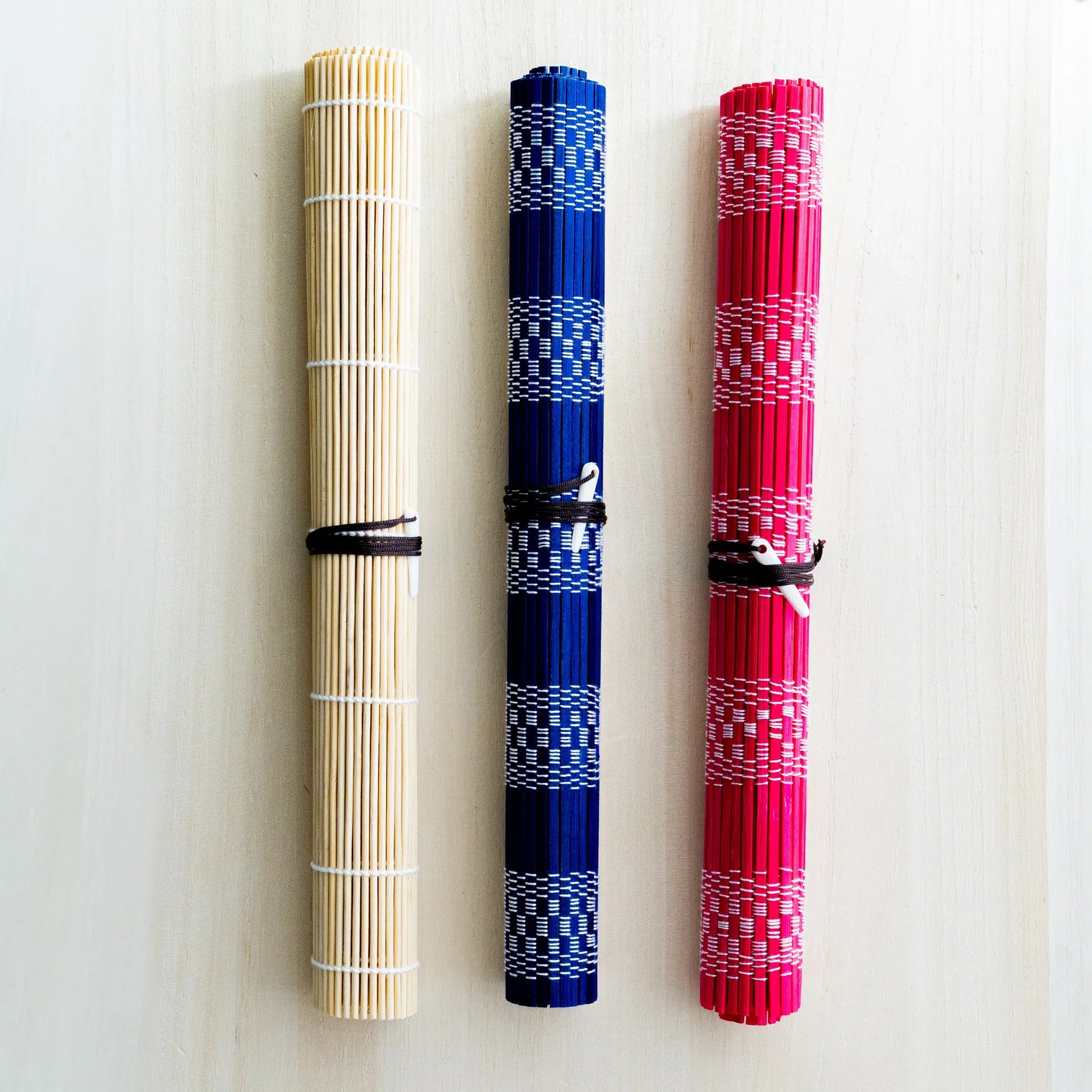 Akashiya bamboo brush holder roll (fudemaki): all three color options Beige, Blue and Red rolled and tied