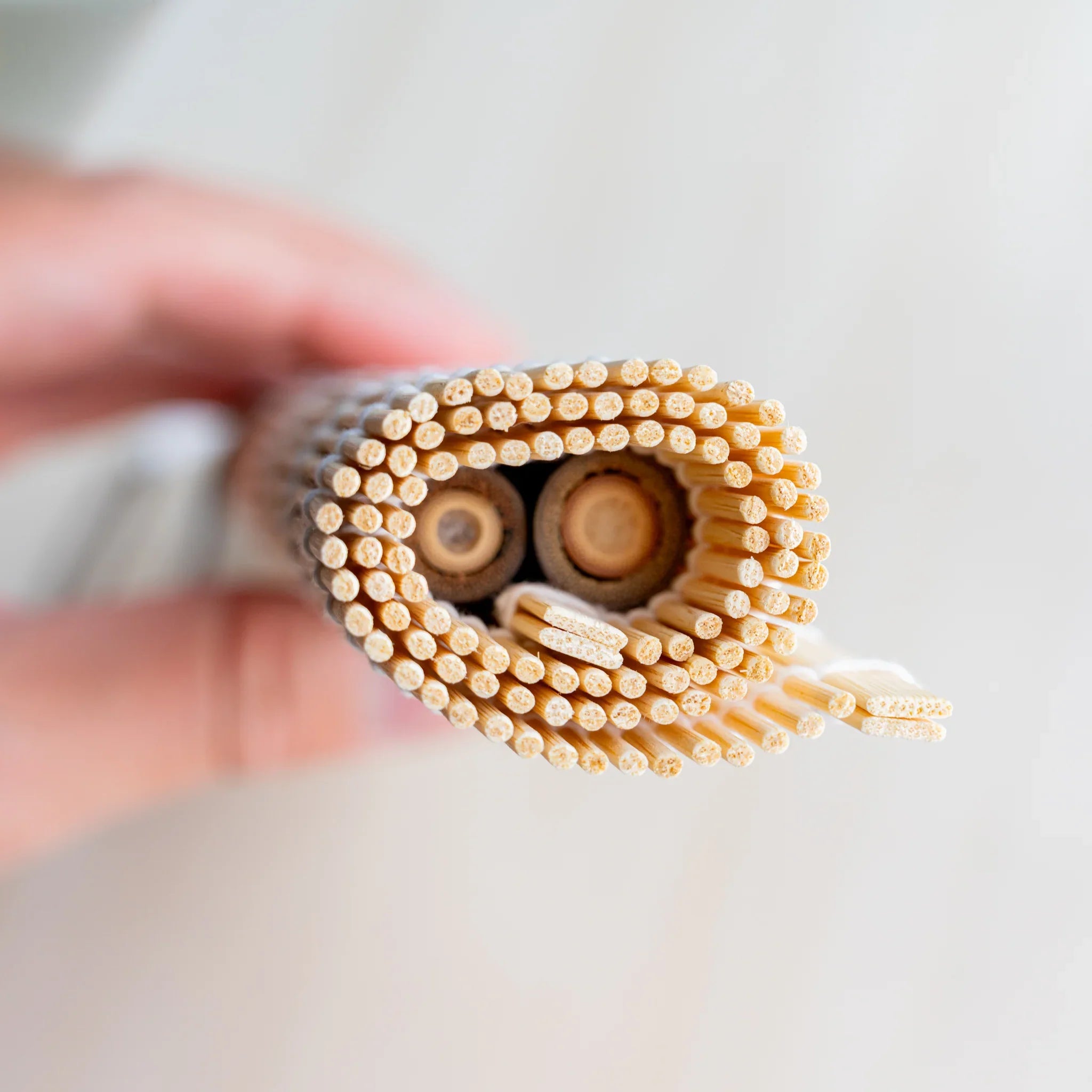 Akashiya bamboo brush holder roll in use, with sumi-e brushes wrapped inside the rolled mat for transport