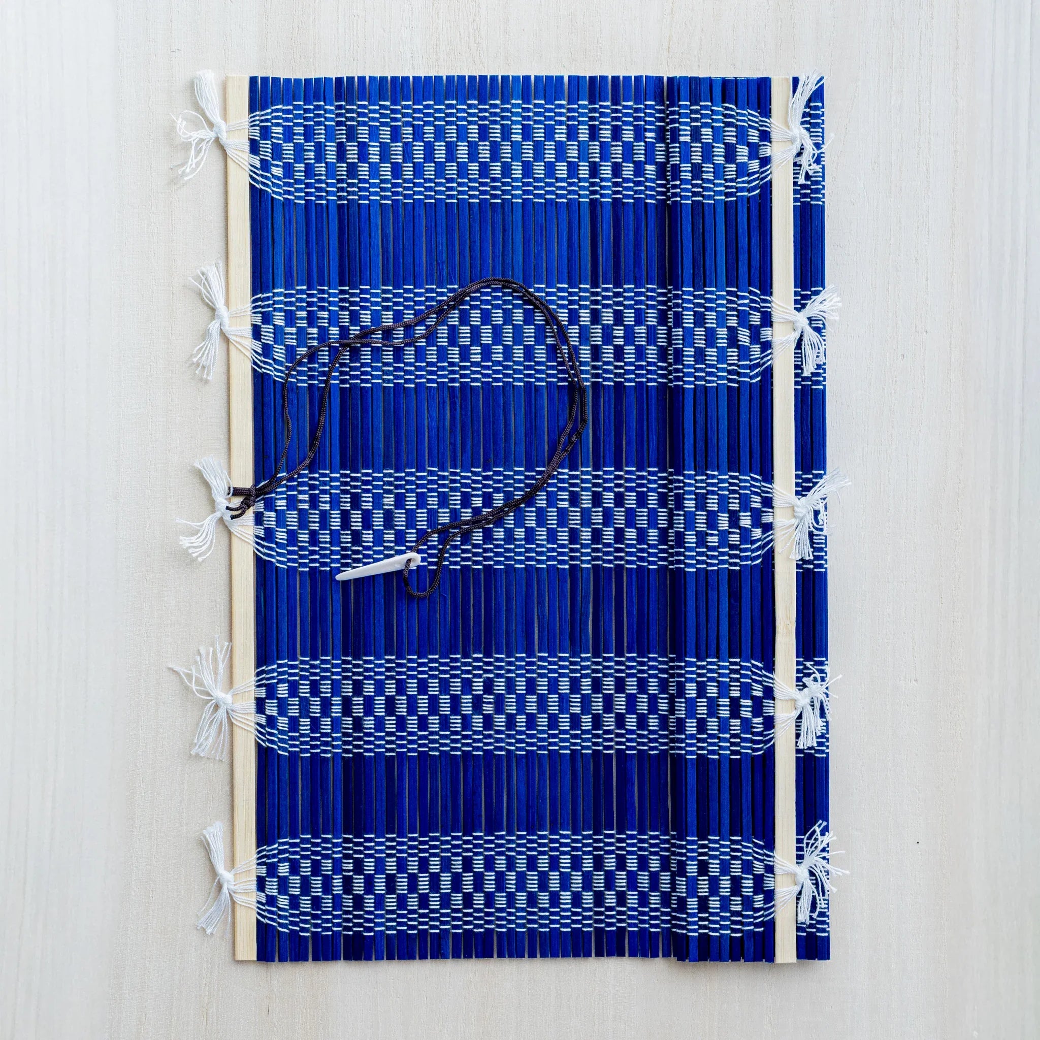 Akashiya bamboo brush holder roll, blue color, rolled and tied with cord