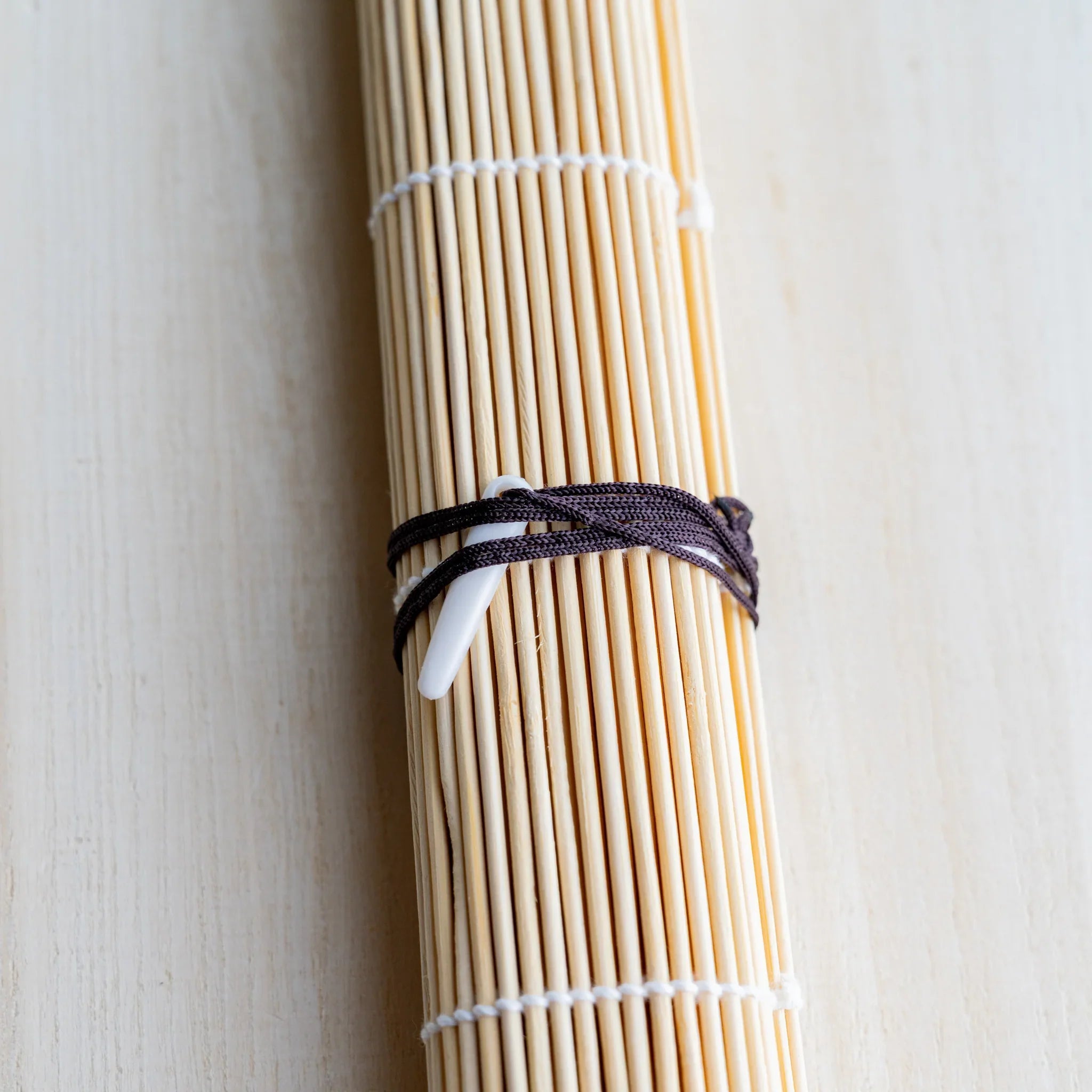 Akashiya bamboo brush roll close-up of the cotton cord and toggle clasp