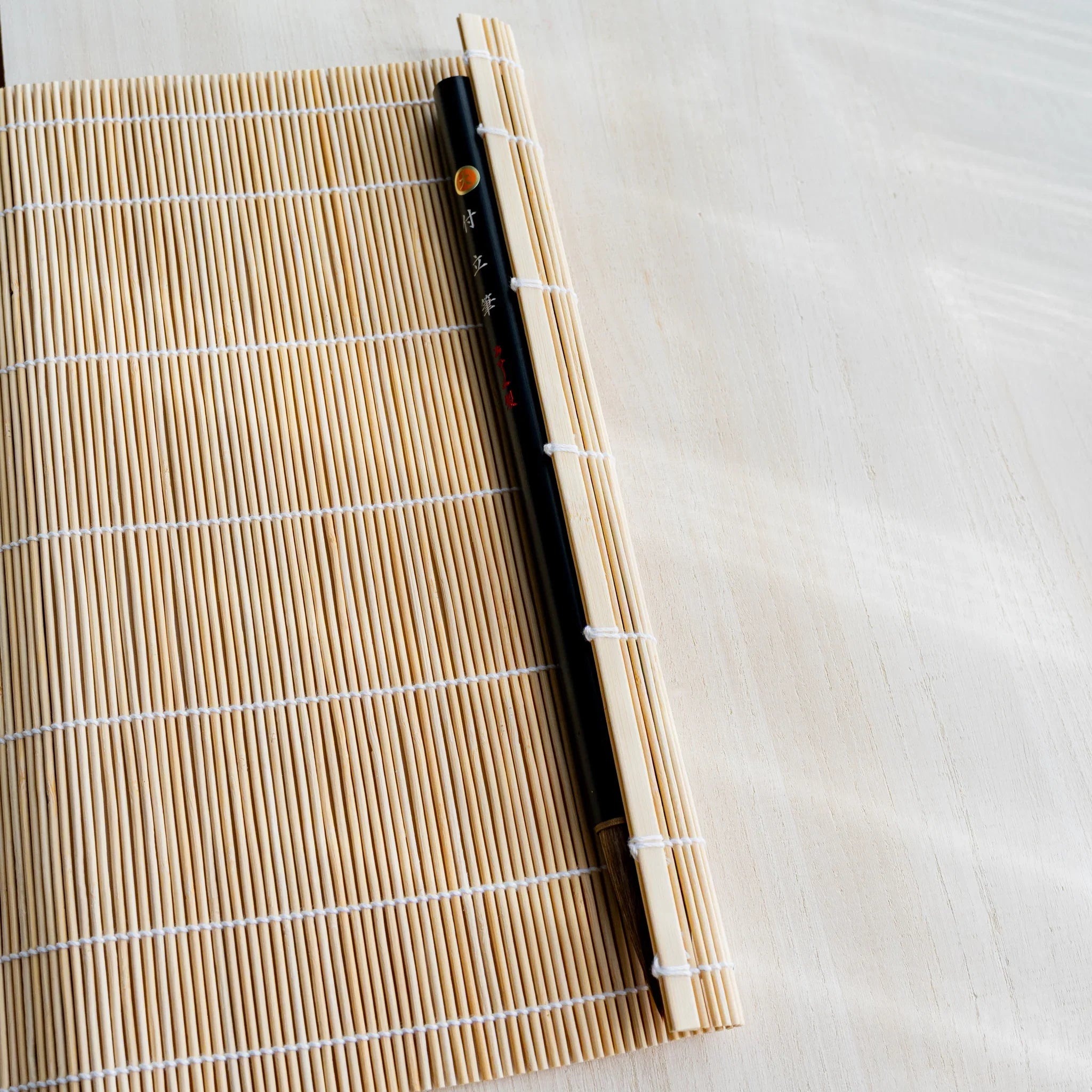 Akashiya bamboo brush holder roll partially rolled to show interior weave