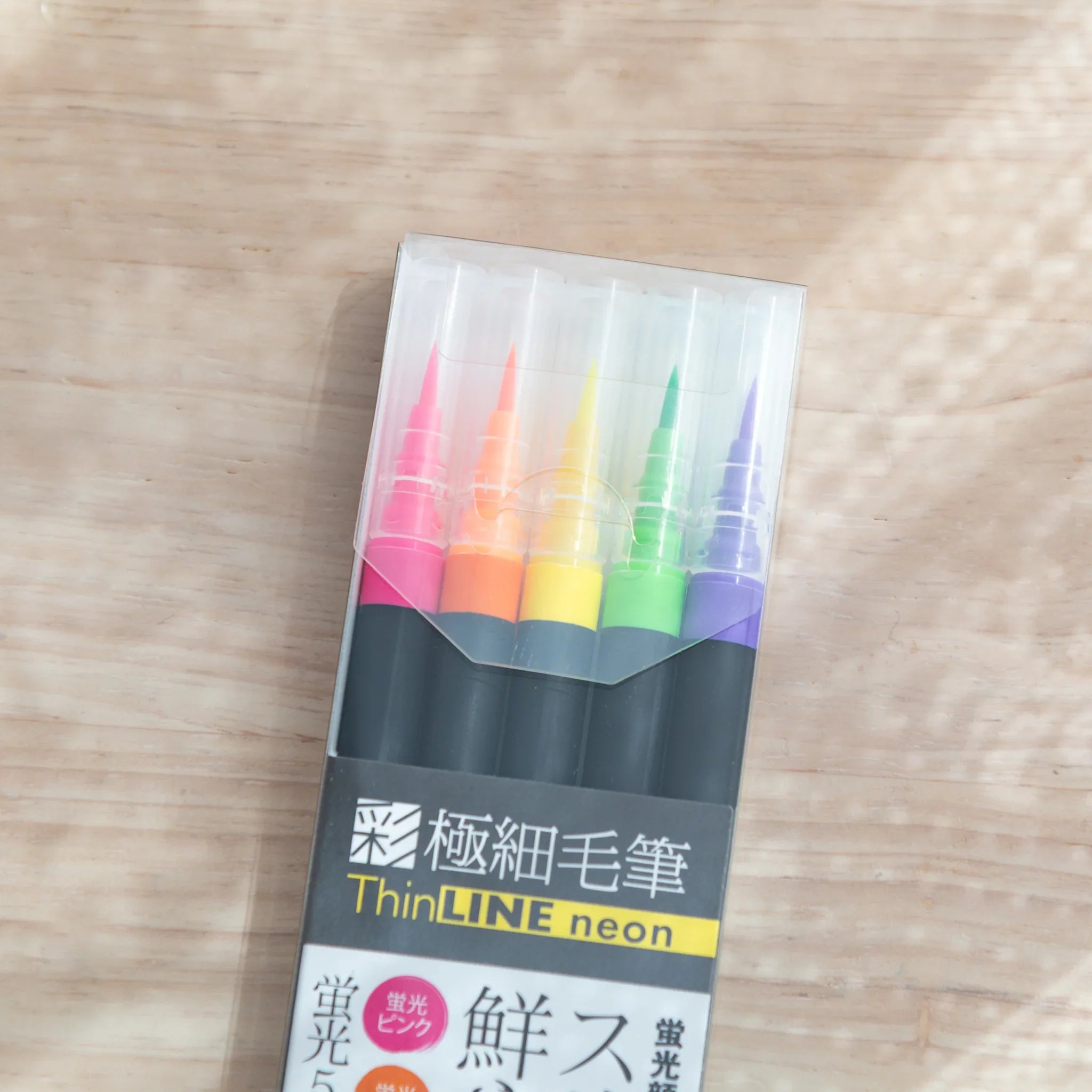 Neon brush pen tips arranged displaying bright saturated fluorescent colors for vibrant illustration work