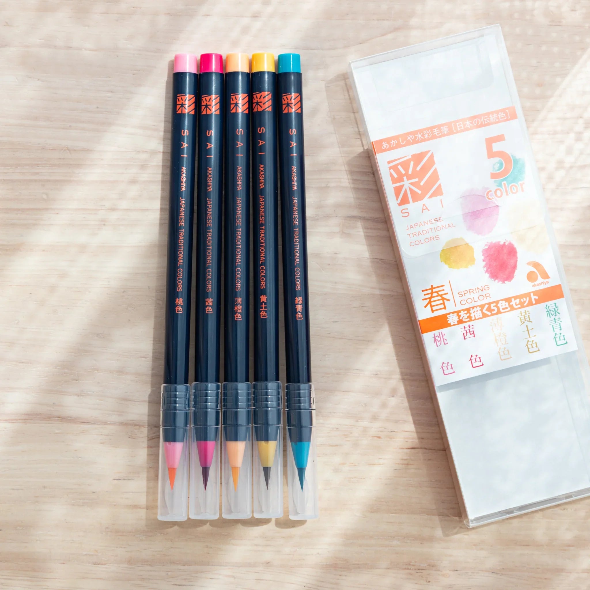 Five pastel watercolor brush pens showing spring colors including soft pink, light blue, mint, yellow