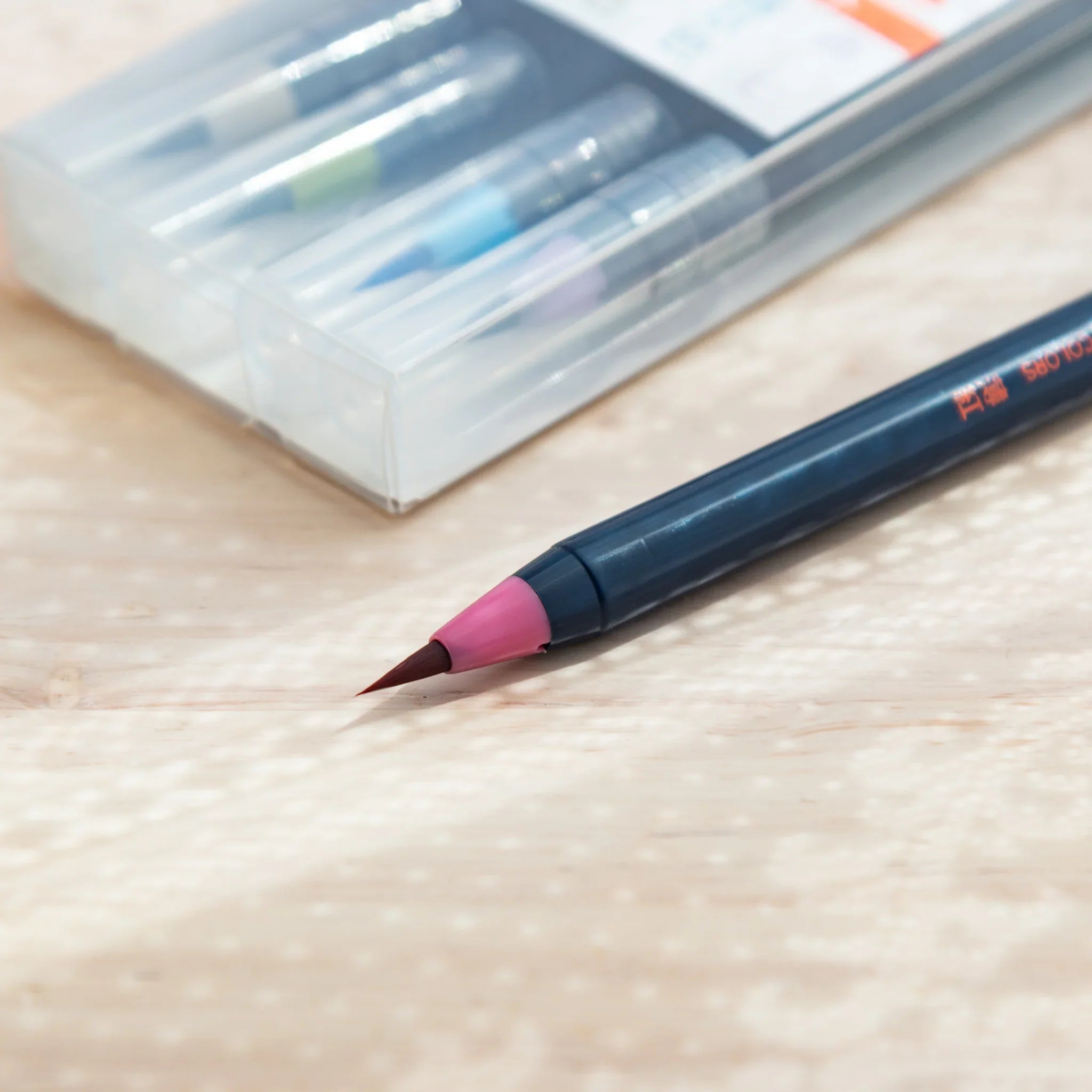 Packaging box for Akashiya Sai subtle color brush pen set featuring soft muted-tone color swatch palette