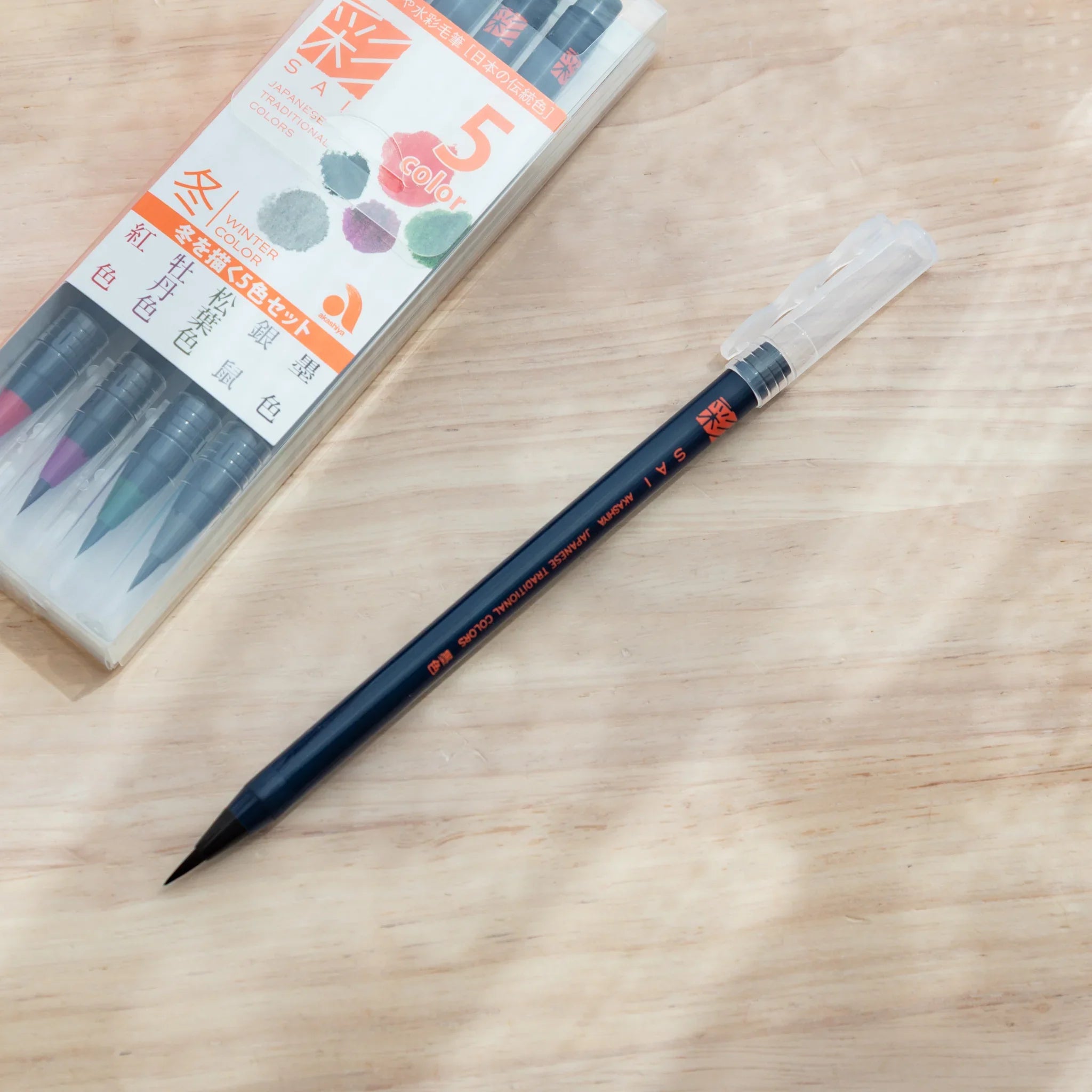 Packaging box for Akashiya Sai winter color brush pen set featuring cool icy-tone color swatch palette