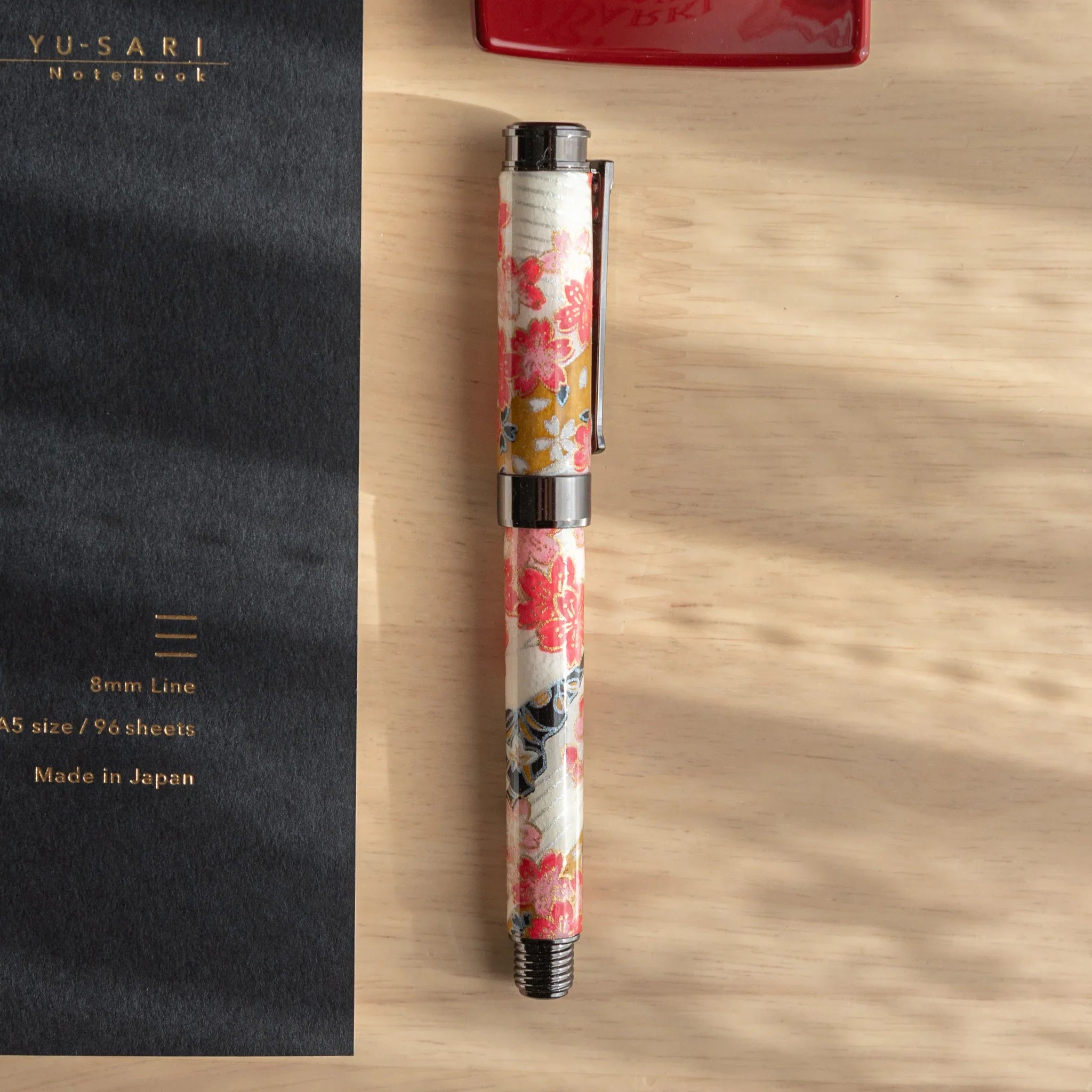 TACCIA Akebono fountain pen with cream Mino washi featuring red cherry botanical pattern and gold accent details throughout