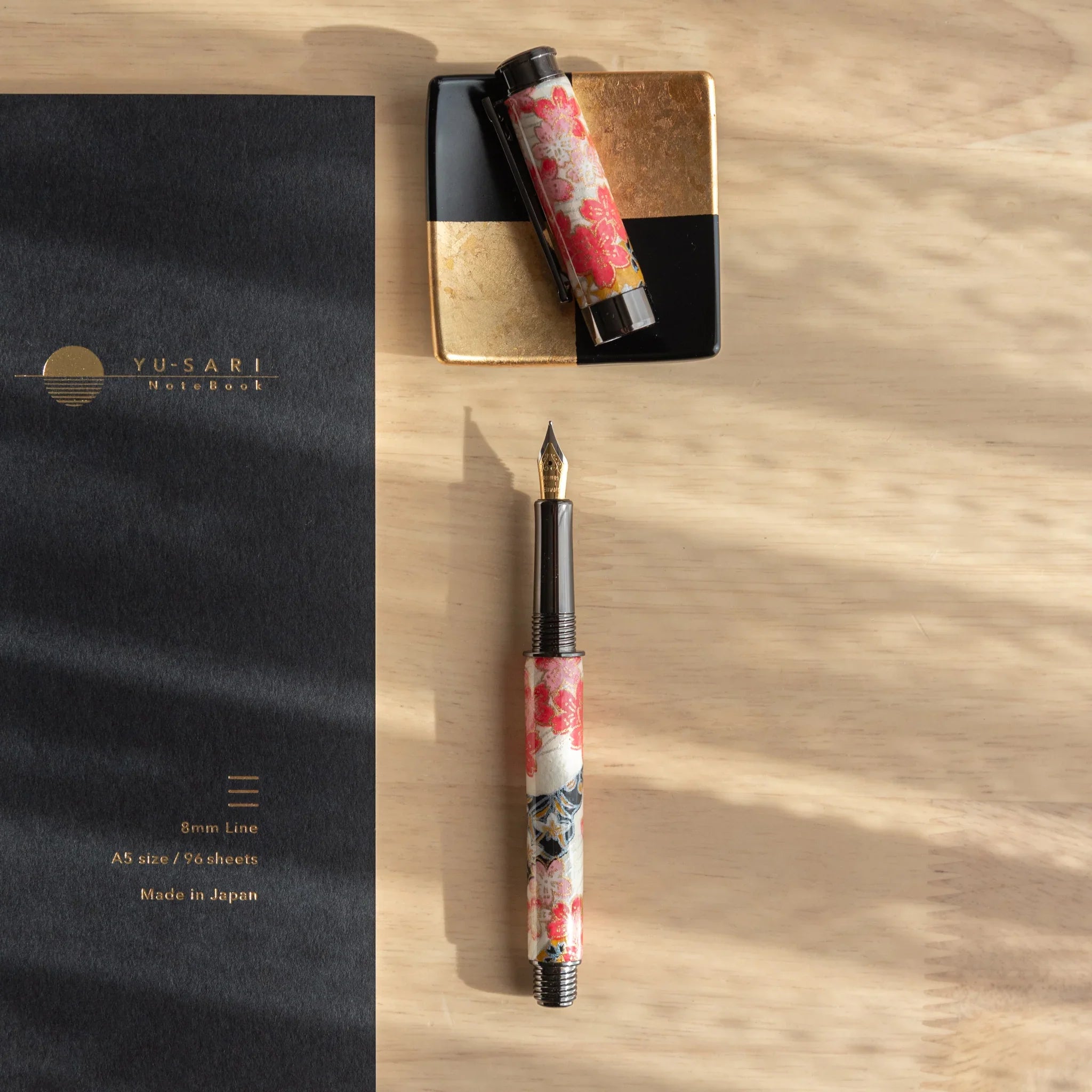Akebono Cherry Mino Washi fountain pen showing complete red cherry pattern with gold metallic accents angled view