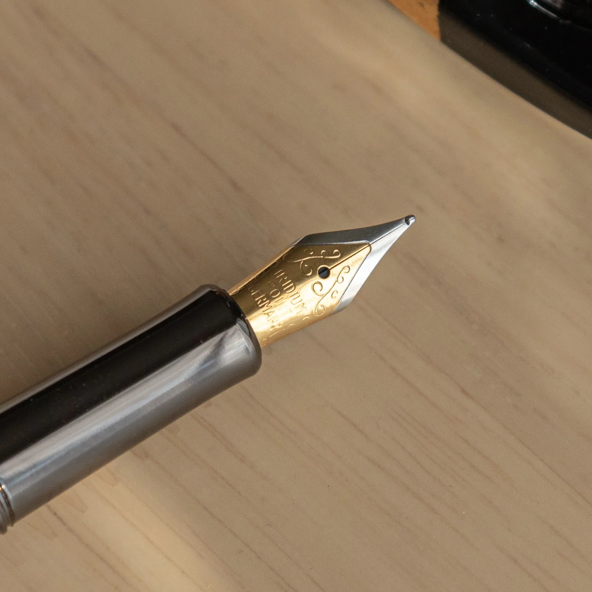 Uncapped Akebono Cherry Mino Washi fountain pen with cream Mino washi and red cherry pattern displayed with nib