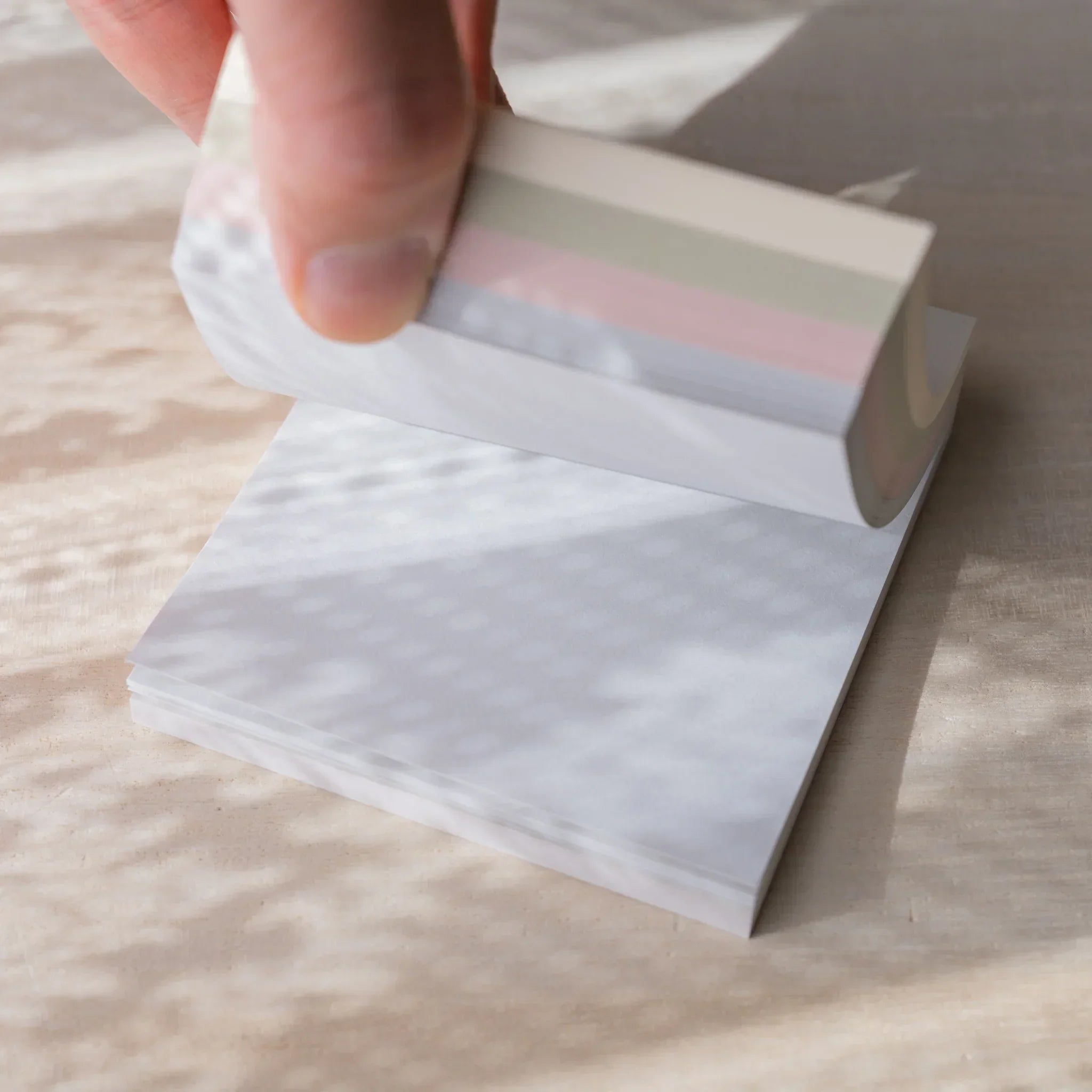 Five pastel colored memo pads arranged showing variety of soft pastel colors for different note-taking purposes