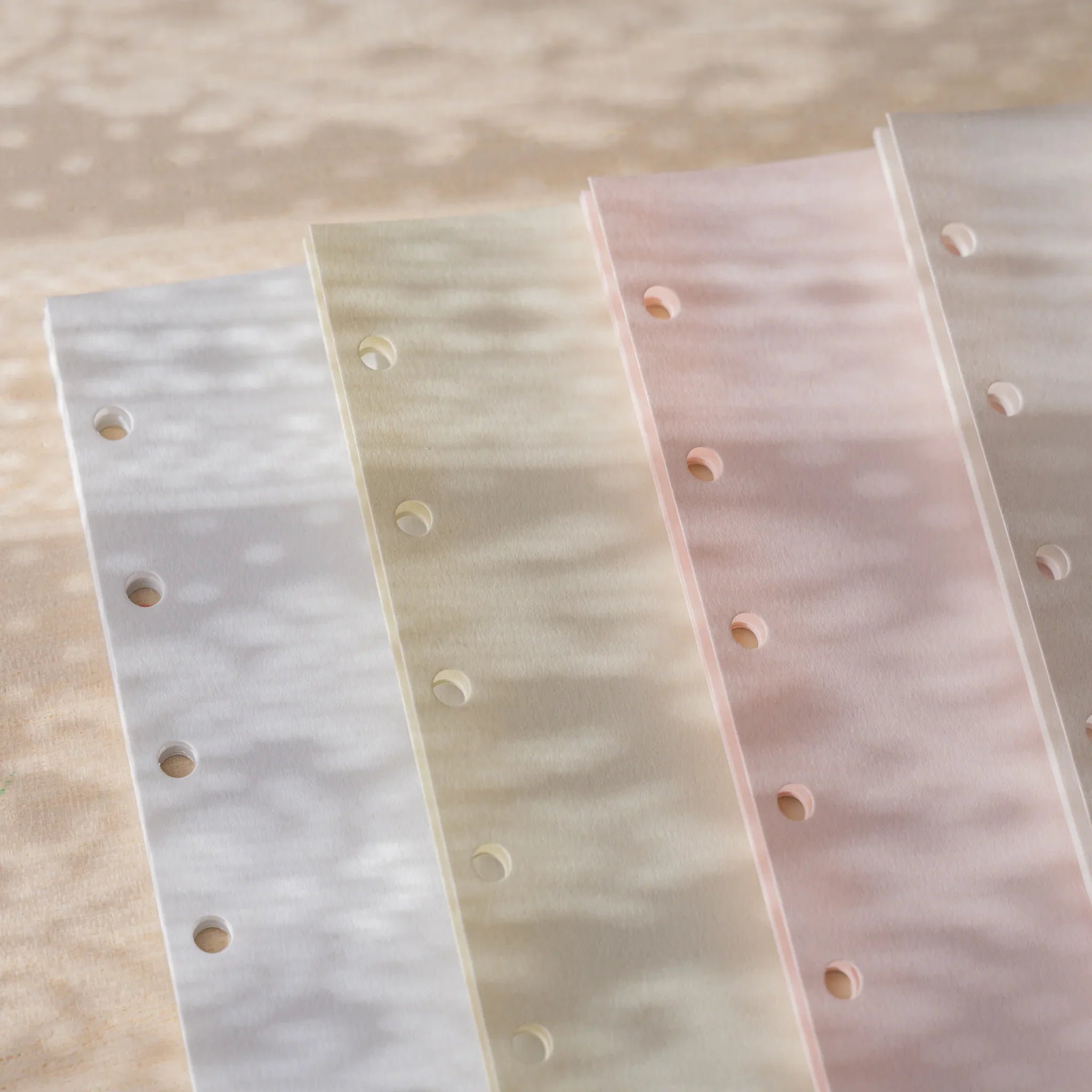 Four Araveal Mini 6 planner refill colors at an angle: slate blue, sage green, primrose, and natural.