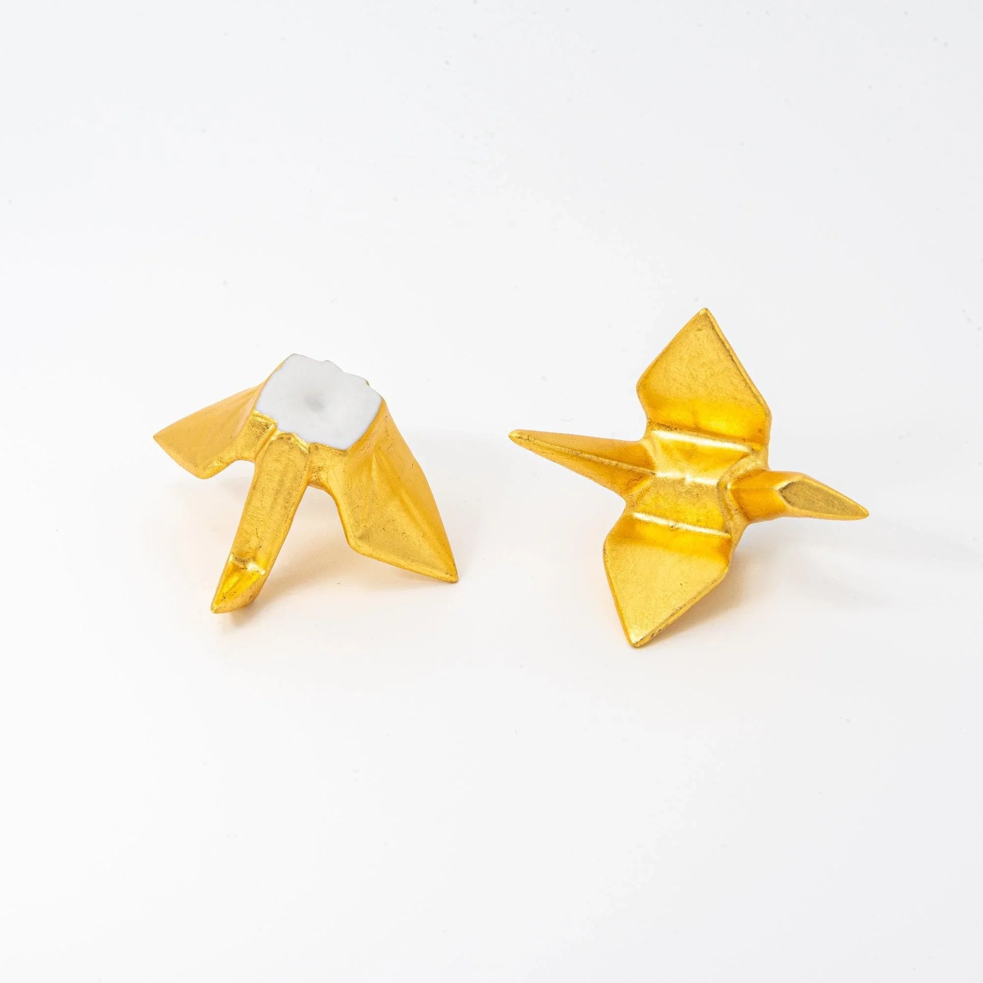 Single Japanese gold ceramic crane pen rest with intricate crackle-pattern texture showing auspicious folded form