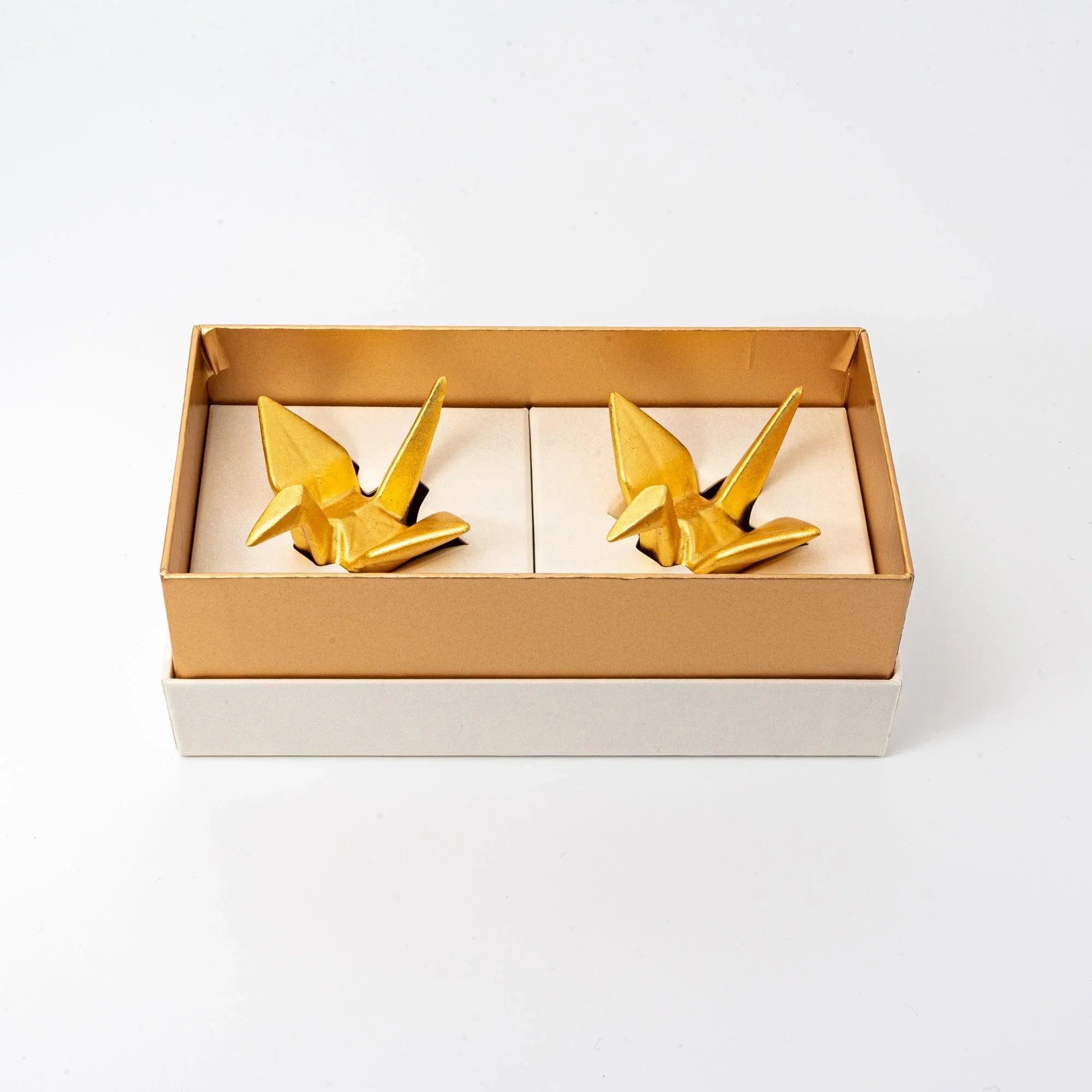 Pair of Japanese gold ceramic auspicious crane pen rests nested in cream-colored gift box, angled three-quarter view