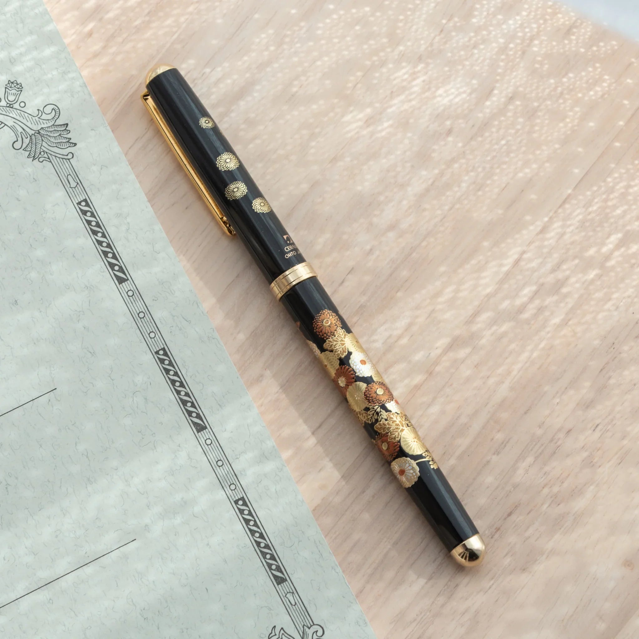 Japanese Yamanaka lacquer ballpoint pen features autumn maple leaf and chrysanthemum flower motif for writing