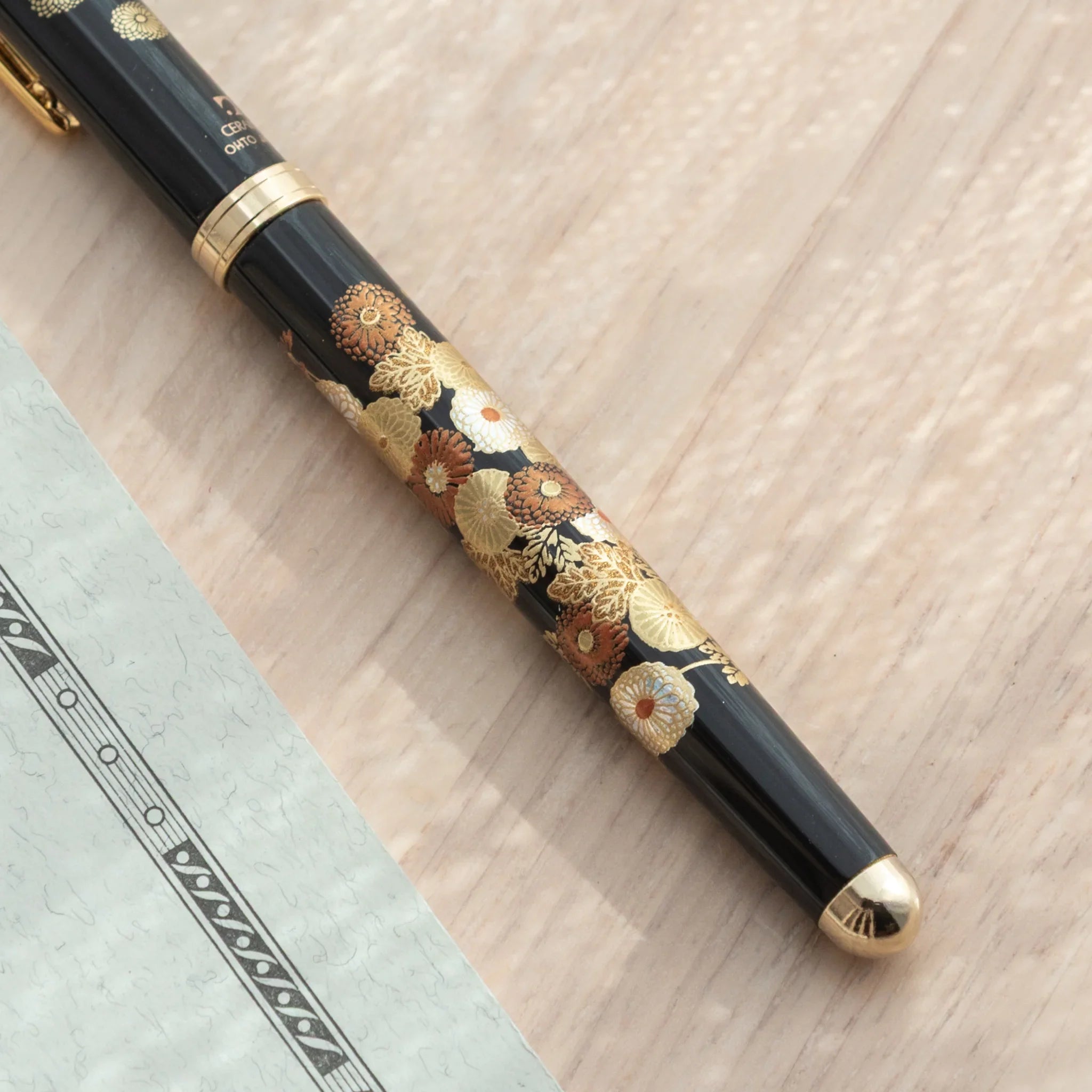 Detailed view of Japanese Fountain Pen's barrel decorated with gold and red chrysanthemums.