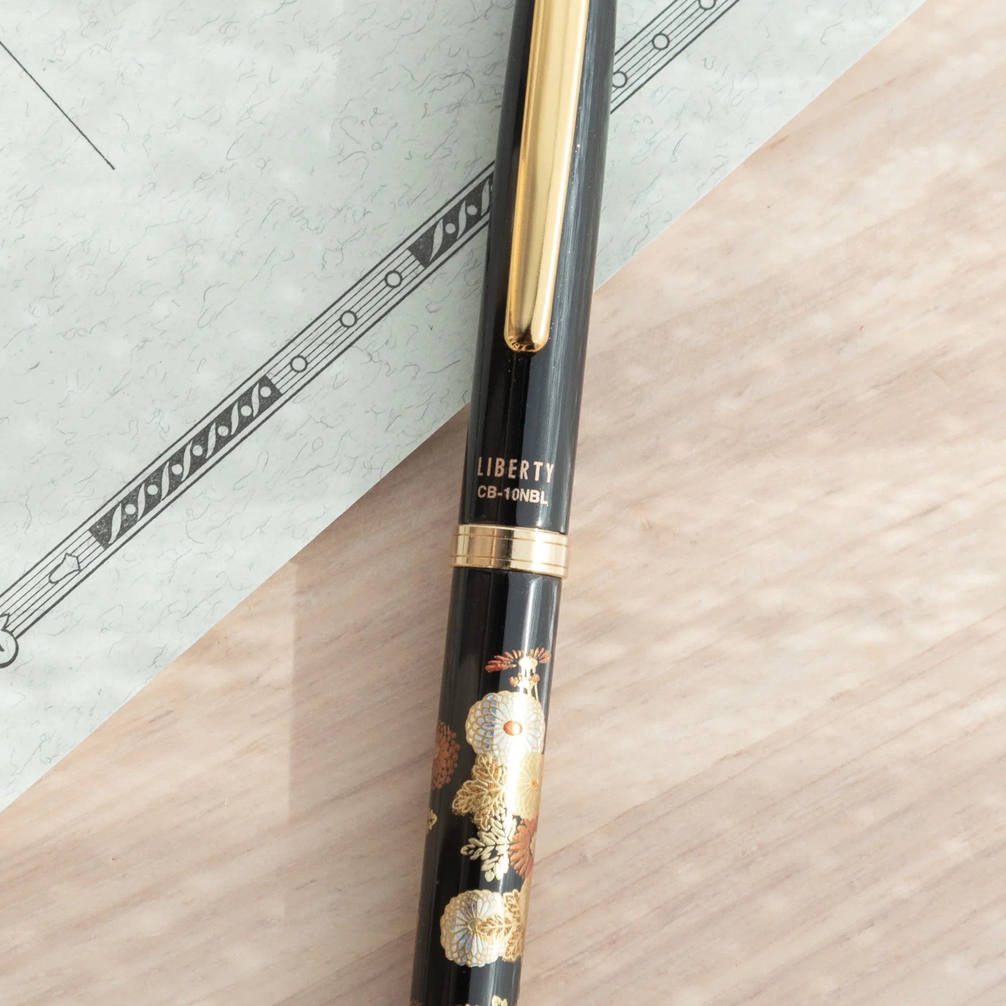 Japanese Ballpoint Pen marked “LIBERTY” with gold clip and ring accents on black lacquer body.