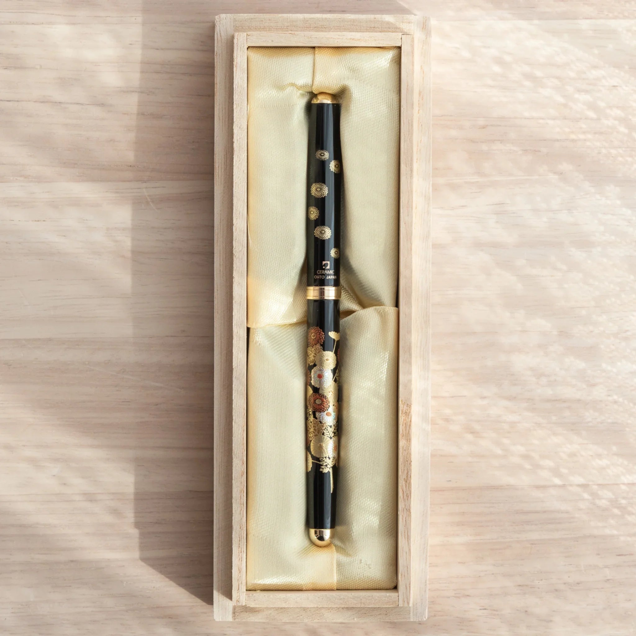 Japanese Ballpoint Pen with floral patterns displayed in a silk-lined black box, elegant and traditional in design.