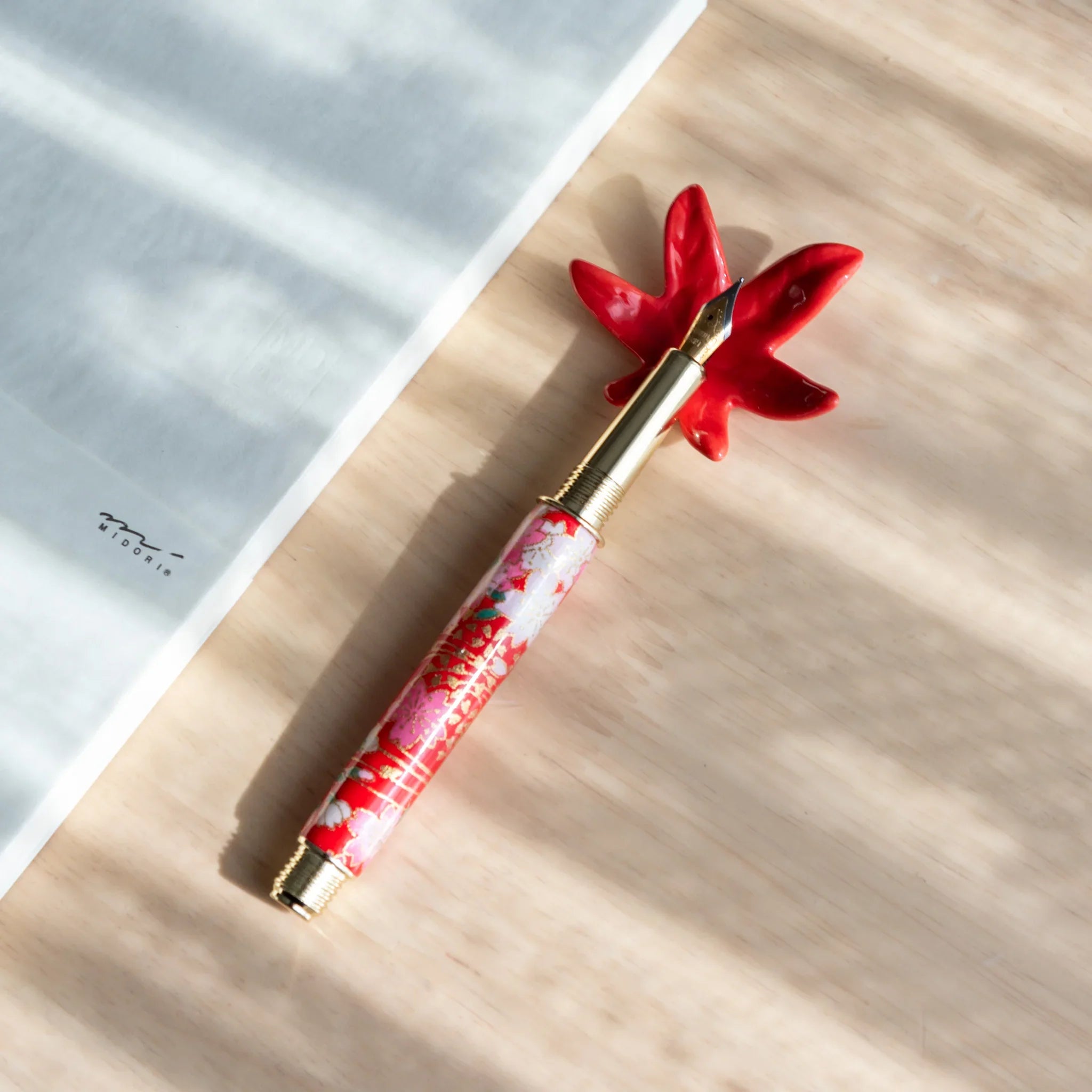 Detailed autumn maple leaf Japanese handcrafted pen rest with carved veining and rich red brown fall coloring throughout