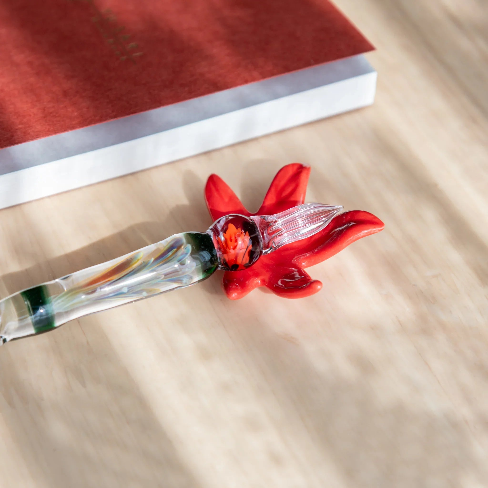 Autumn leaves handcrafted Japanese pen rest with natural warm brown and red tone coloring showing fall season inspiration