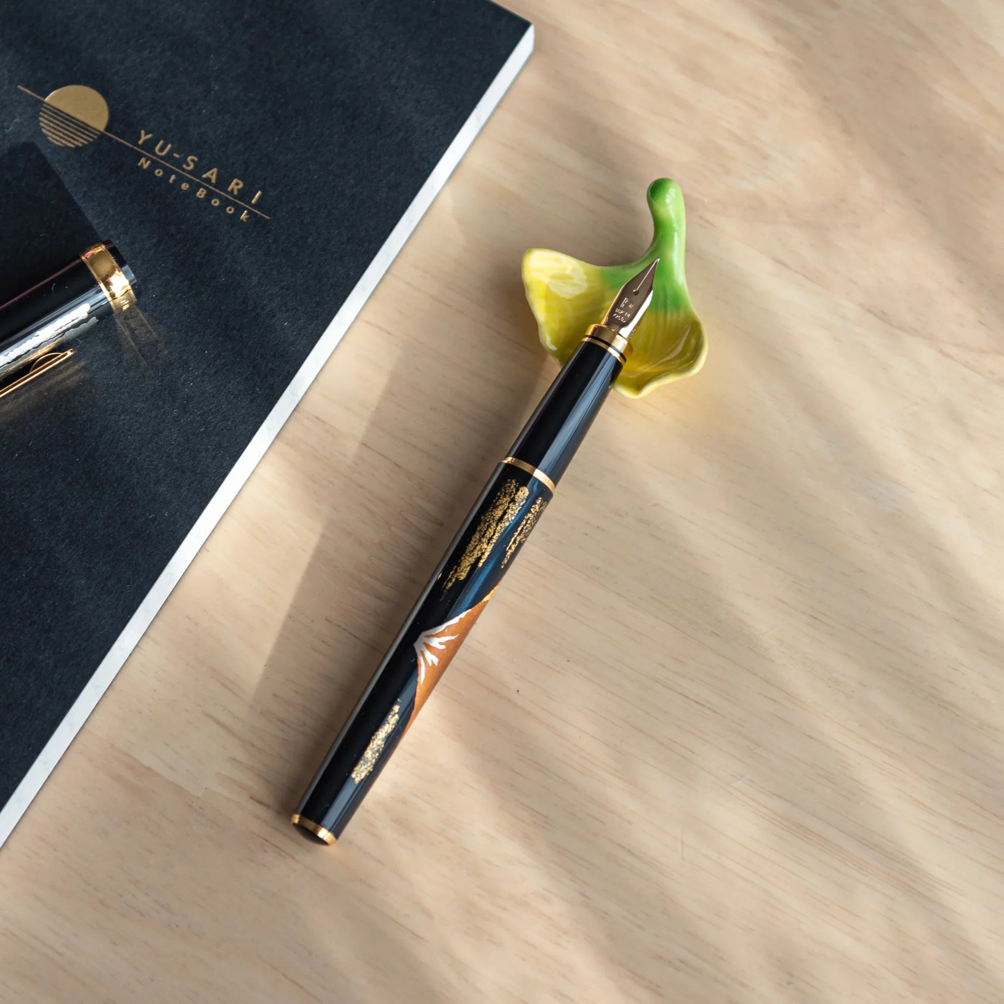 Japanese autumn leaf handcrafted pen rest with color gradient display and detailed surface carving showing fall aesthetic