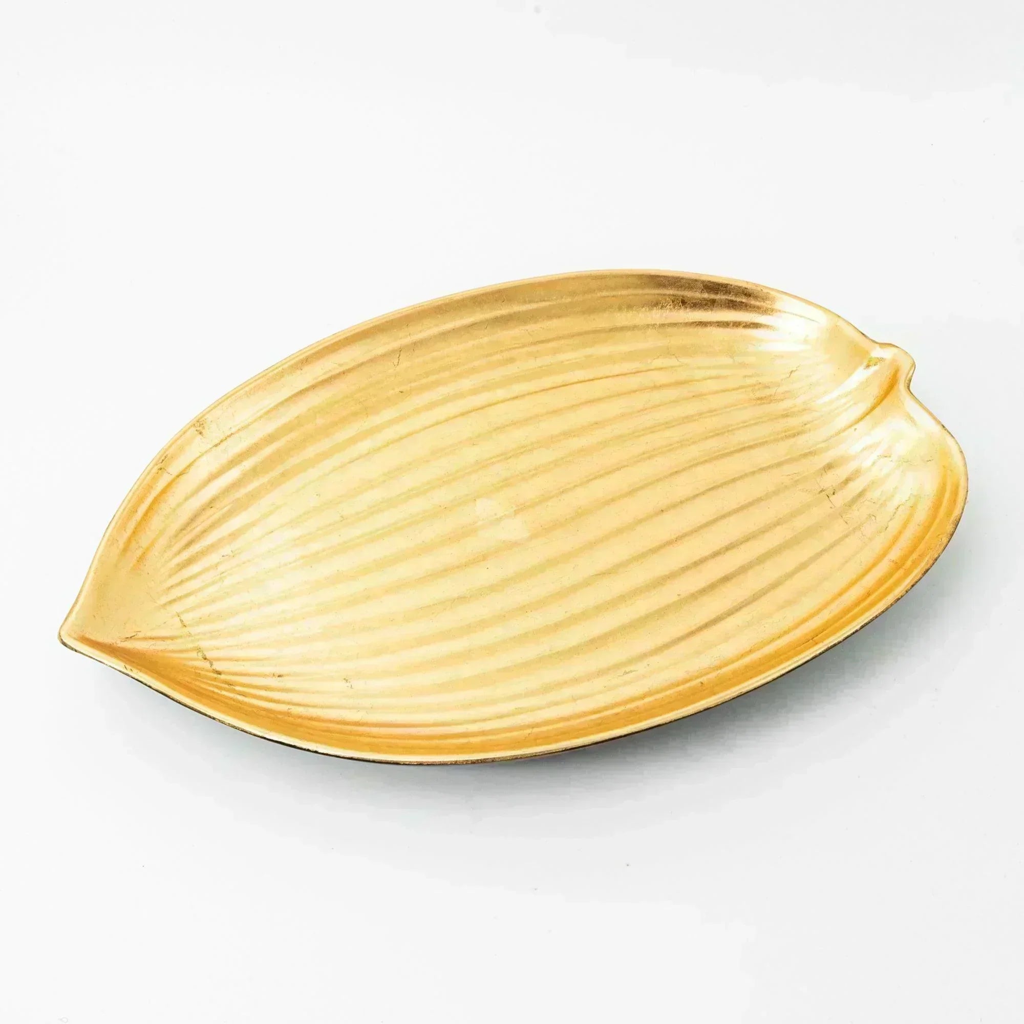 A gold leaf-shaped tray with a textured surface, perfect for displaying Japanese stationery items.