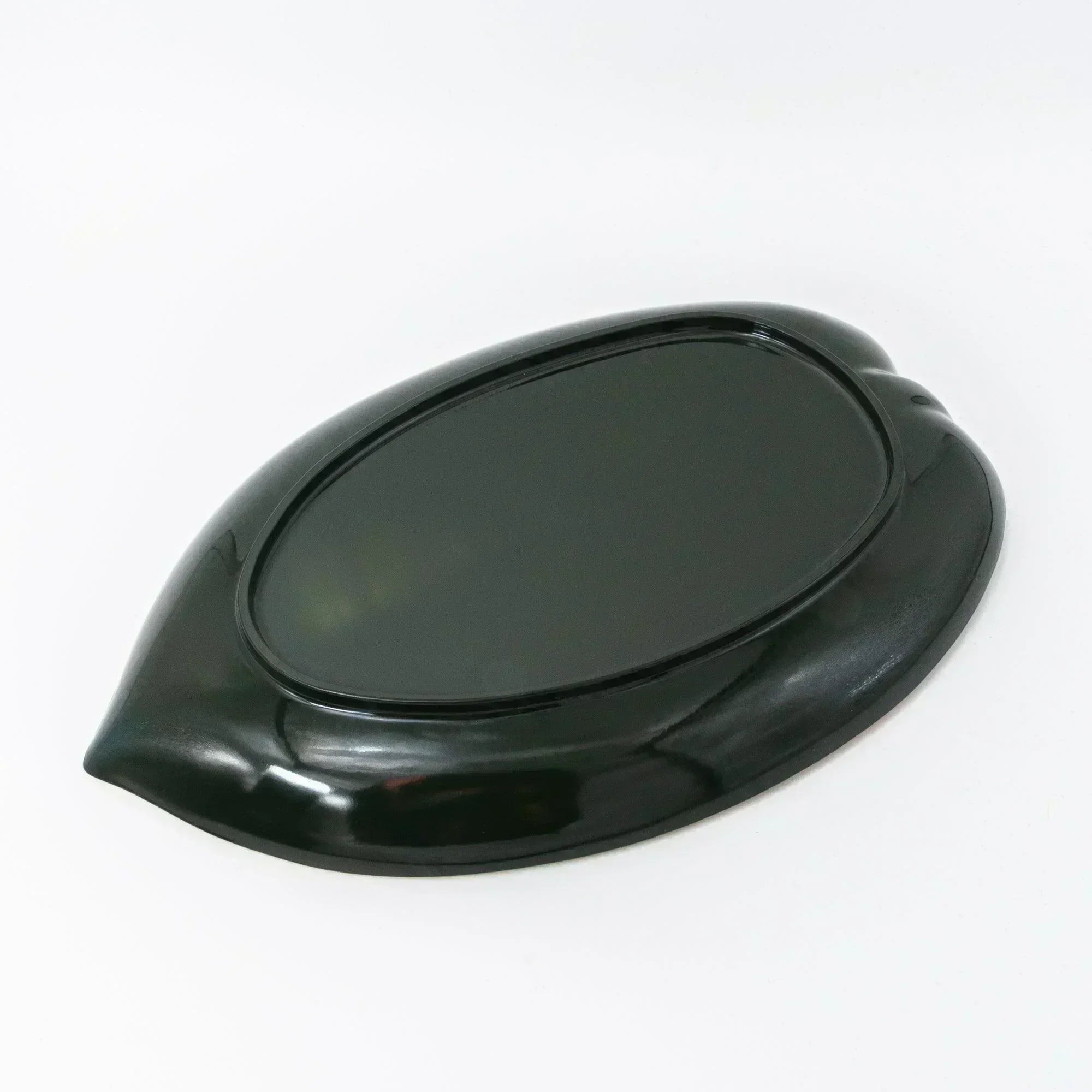 The underside of the tray, featuring a smooth black finish that contrasts with the gold surface.