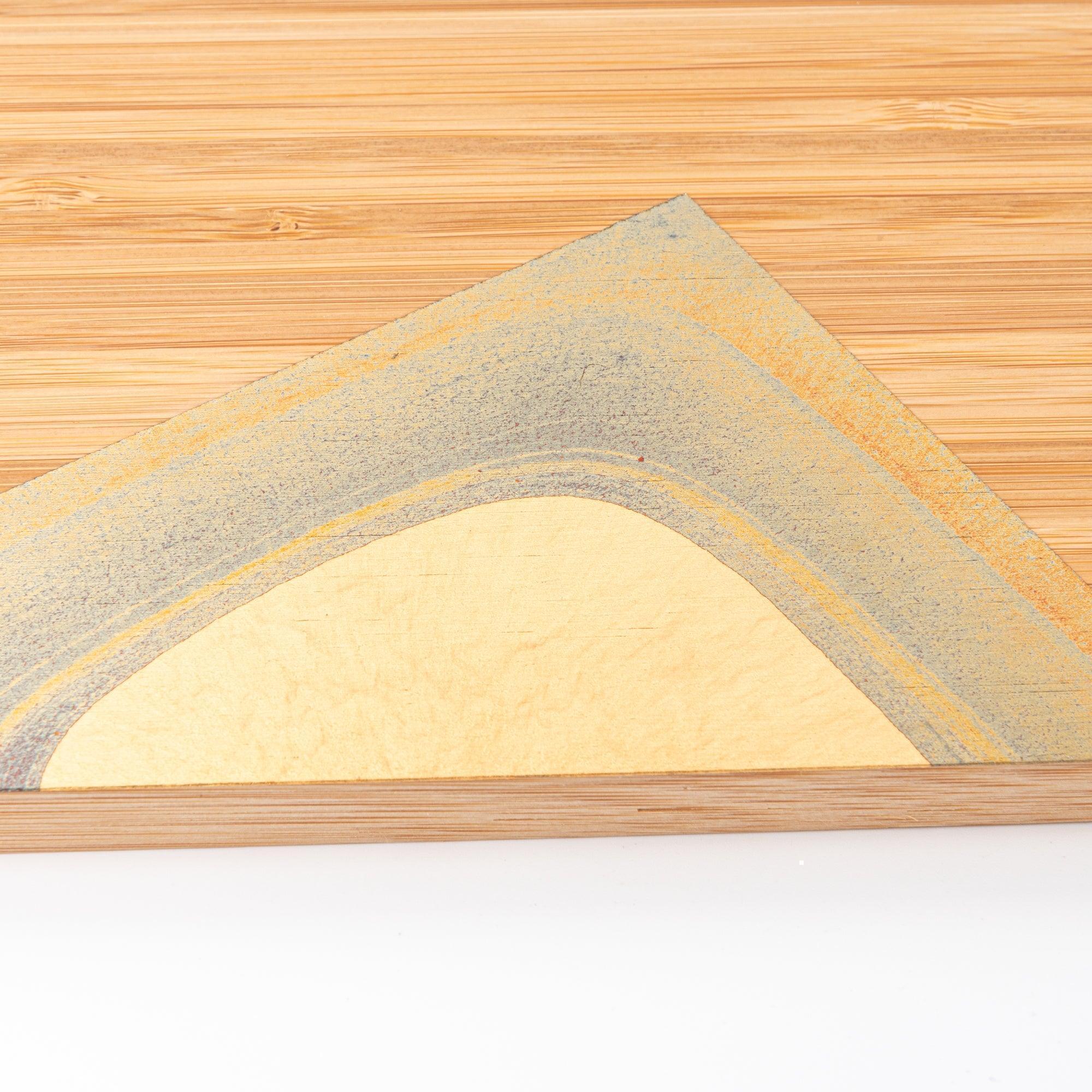A close-up of the gold-accented corner on a bamboo tray, showcasing intricate craftsmanship for Japanese stationery.