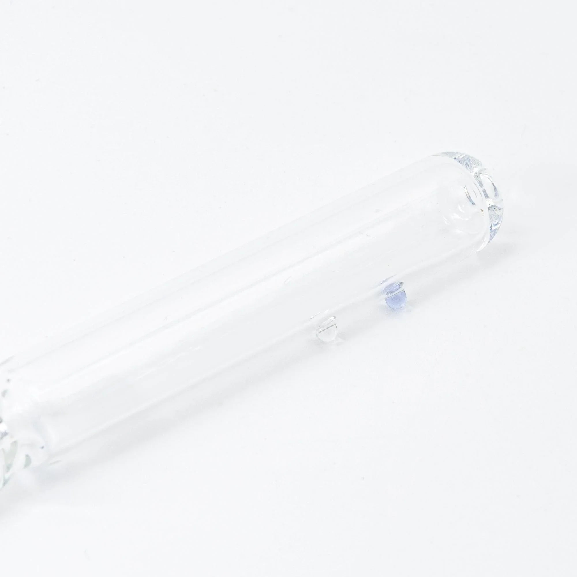 Blue glass dip pen close-up detail showing hand-twisted fine glass nib point for calligraphy and ink writing applications