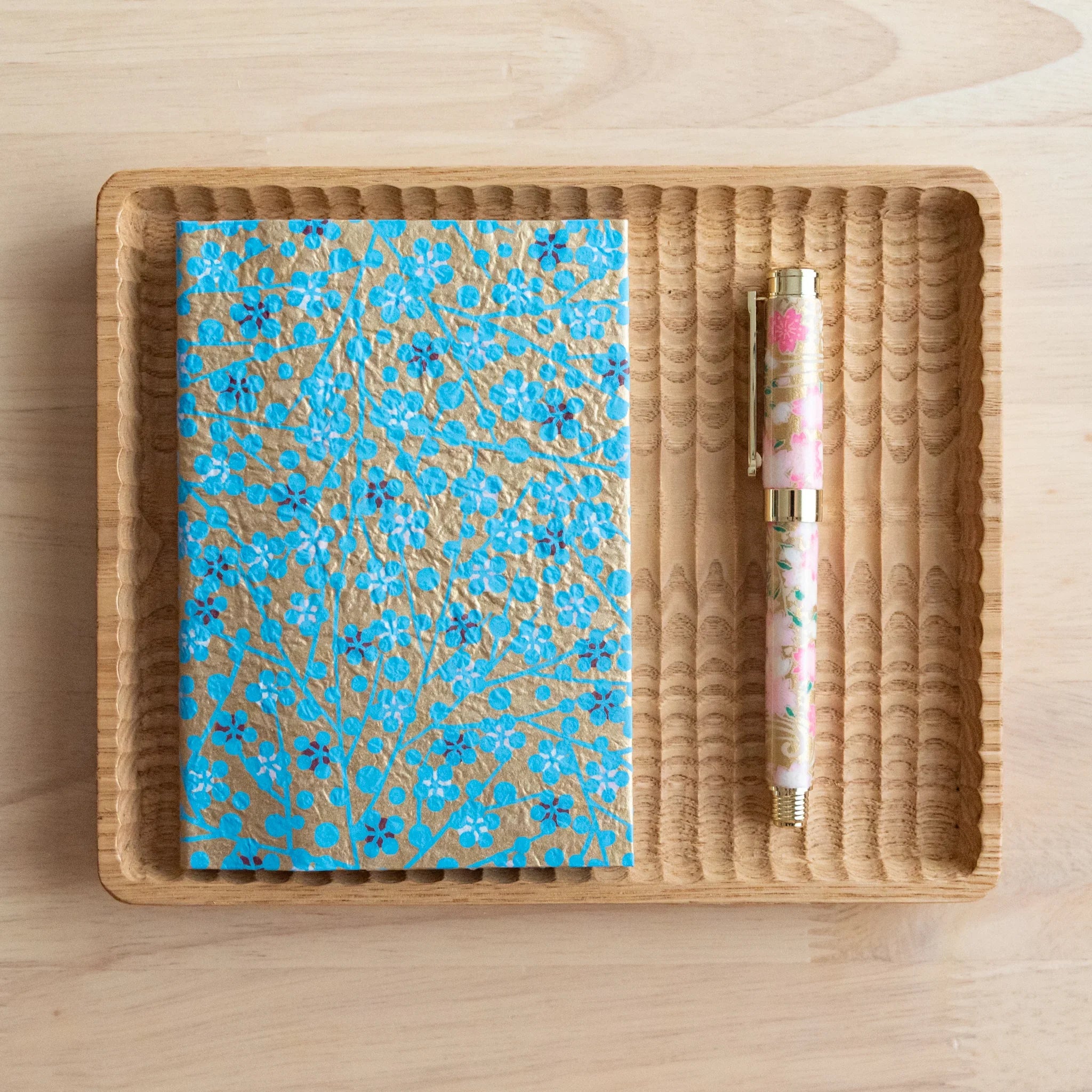Blue floral washi paper book cover showing intricate hand-dyed Yuzen pattern with delicate flower motifs