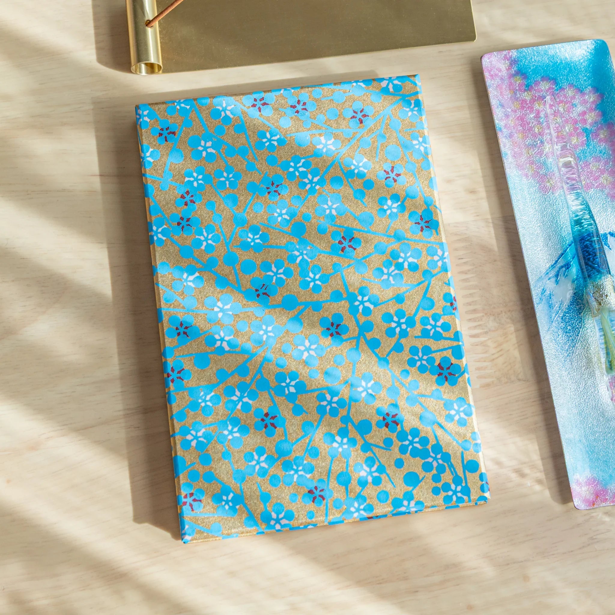 Blue Flower Washi Goshuincho stamp book closed cover showing bright turquoise washi with gold maple leaf pattern