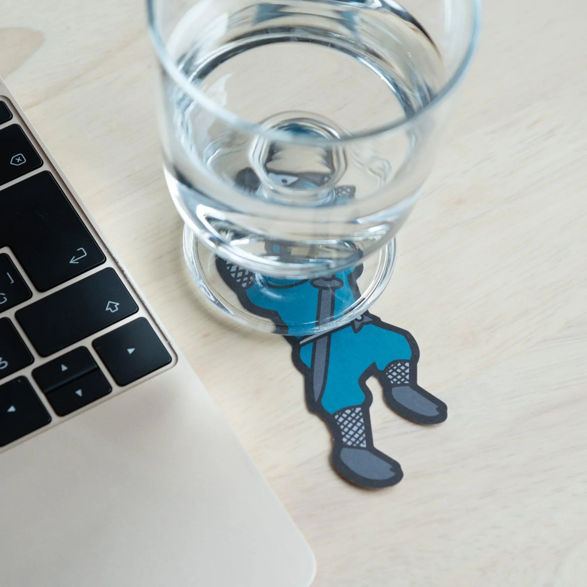 Single blue ninja washi message card placed under clear water glass demonstrating practical use showing product quality an