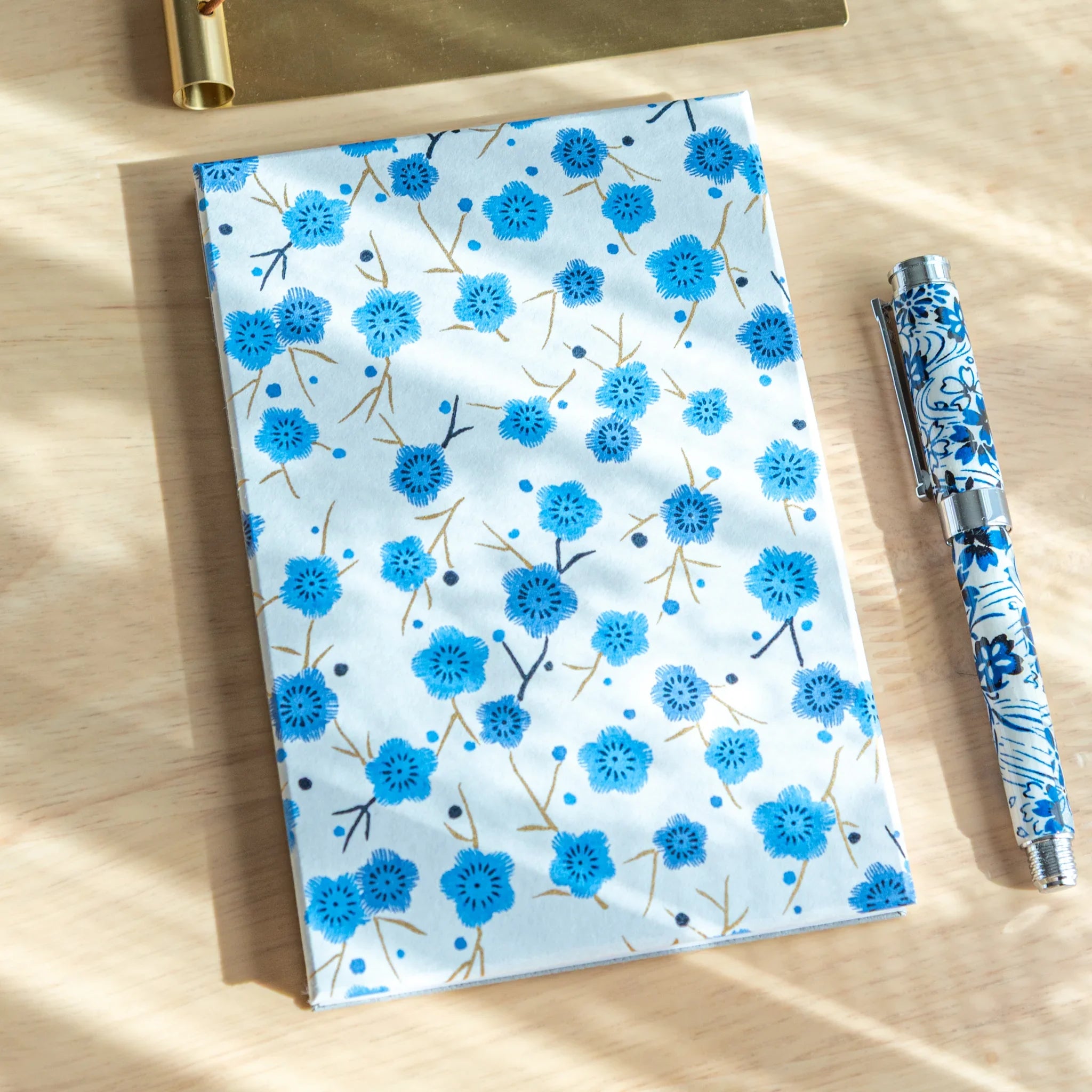 Blue Plum Blossoms washi goshuincho stamp book with light blue on white cover and coordinating blue fountain pen