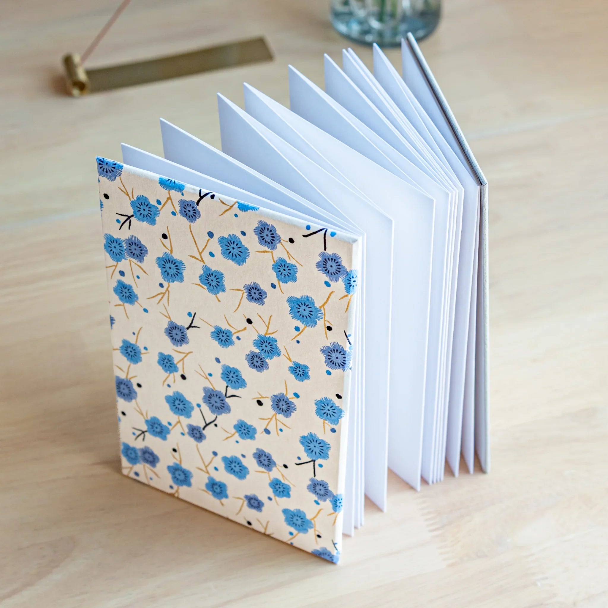 Open view of Blue Plum Blossoms goshuincho showing white interior pages and decorative washi cover showing product quality