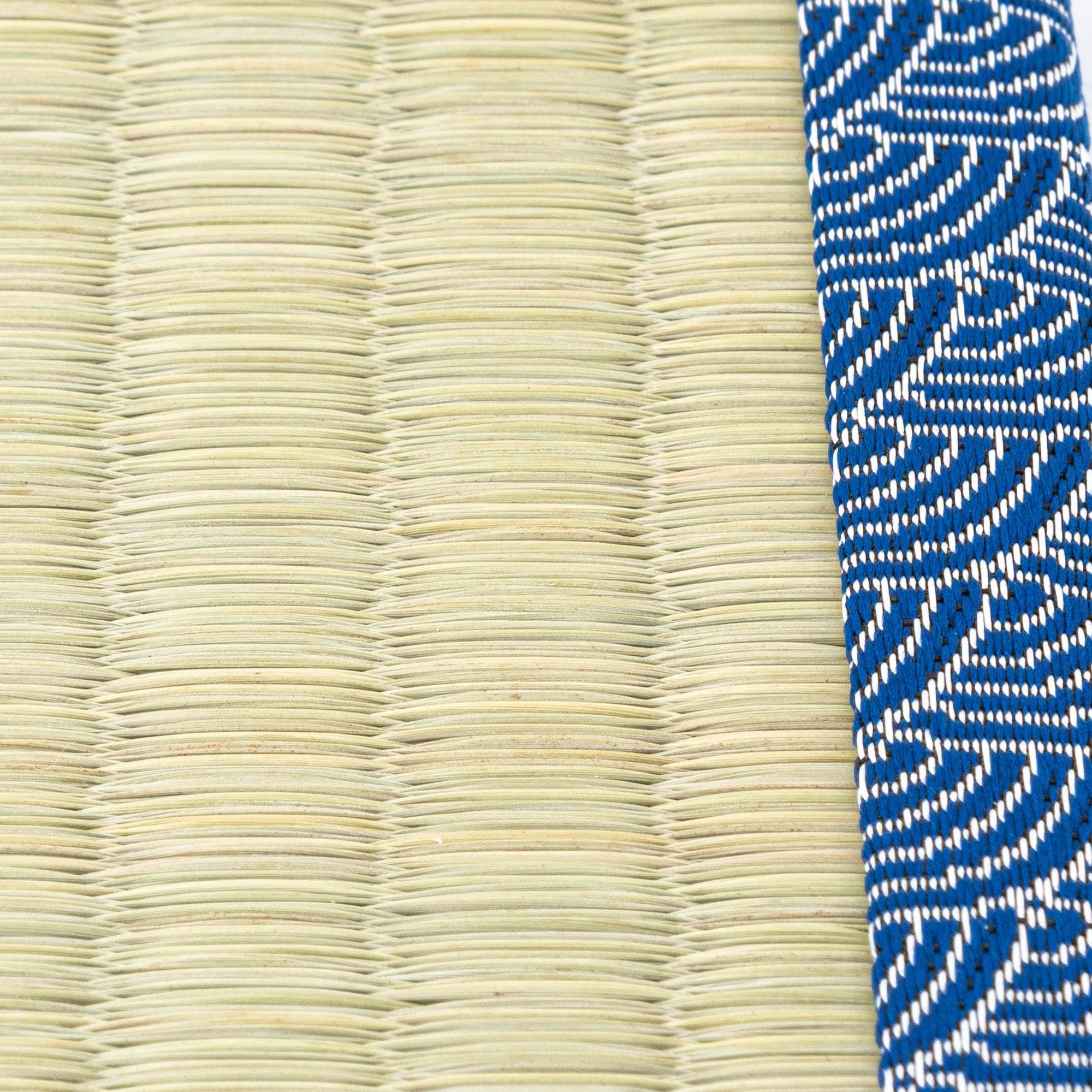 Two black lacquer pens with gold floral and wave motifs resting on a tatami pen tray with blue wave borders, emphasizing refined Japanese stationery.