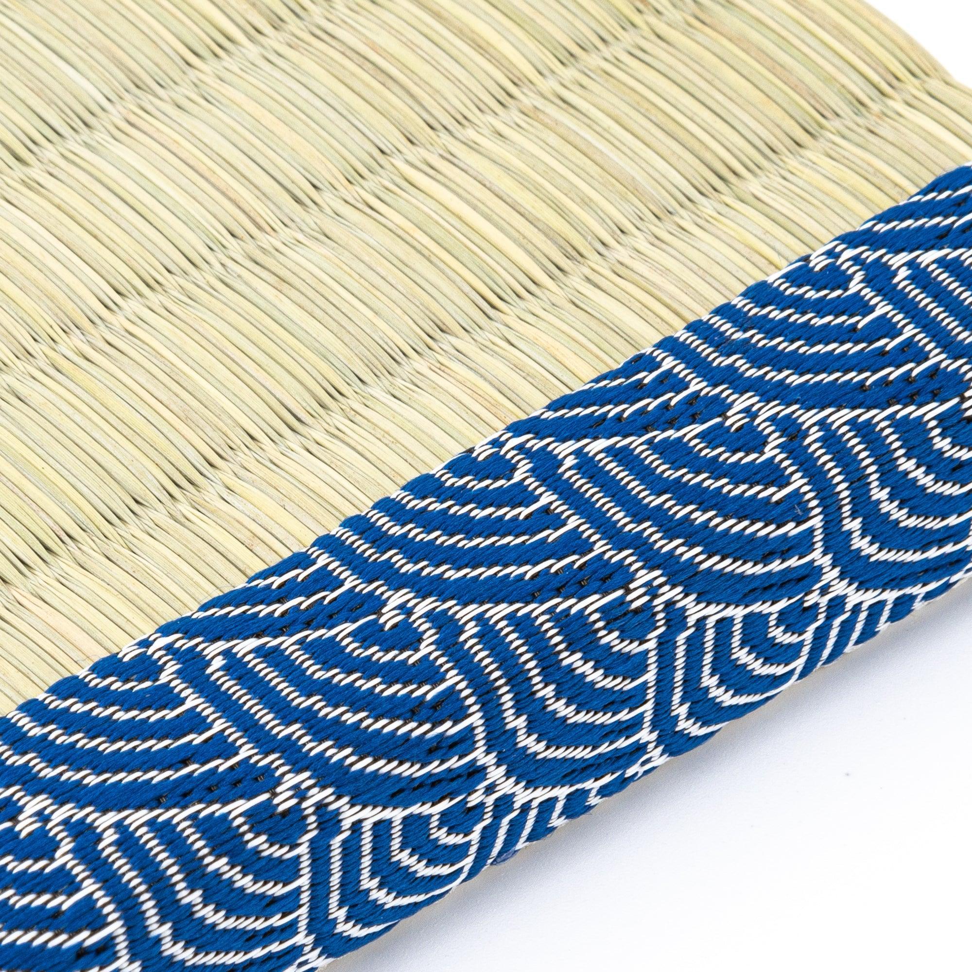 Two glass pens with intricate designs placed on a tatami pen tray bordered with blue wave patterns, showcasing the elegance of Japanese stationery.