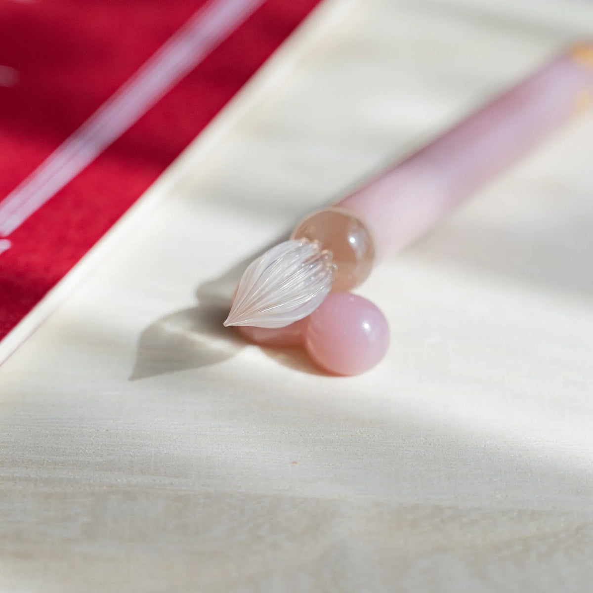 Blush Pink Flowers glass dip pen nib angled down between two pale pink glass pen rest spheres