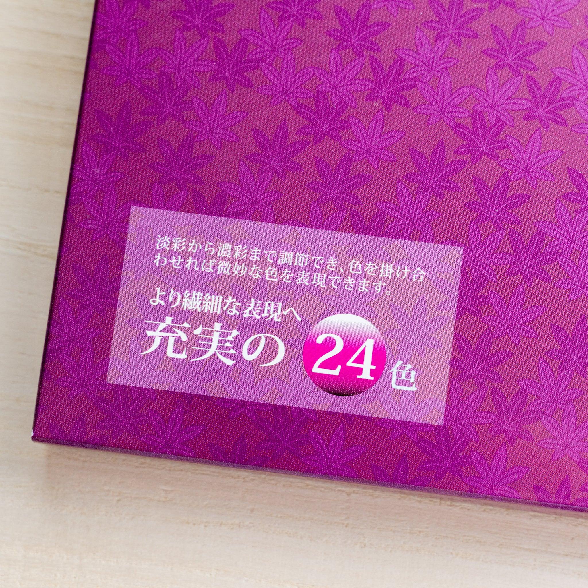 Close-up of corner of closed magenta Gansai box showing maple leaf pattern, brand label, and full 24-color badge