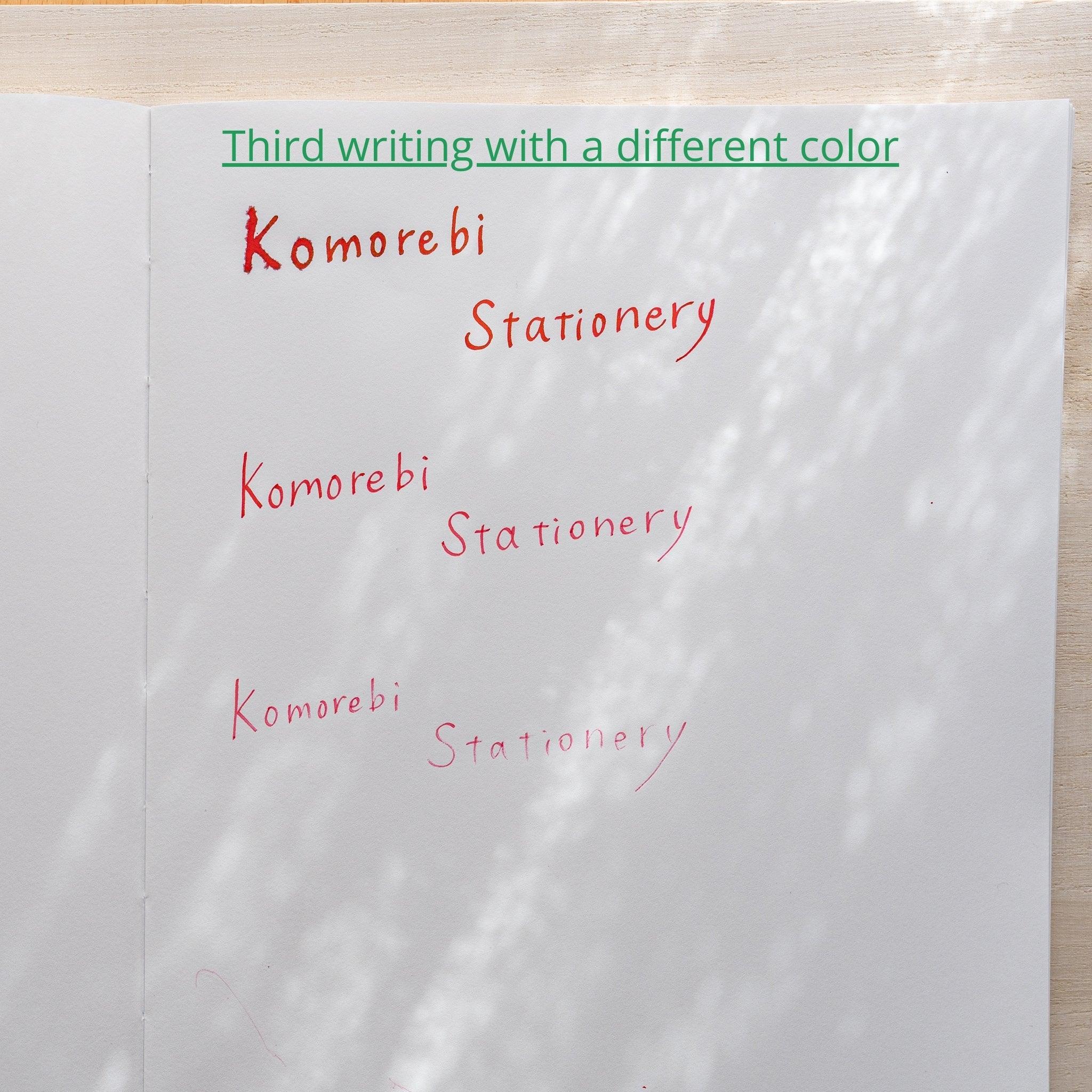 Paper labeled Third writing with a different color showing Komorebi Stationery written three times in red ink