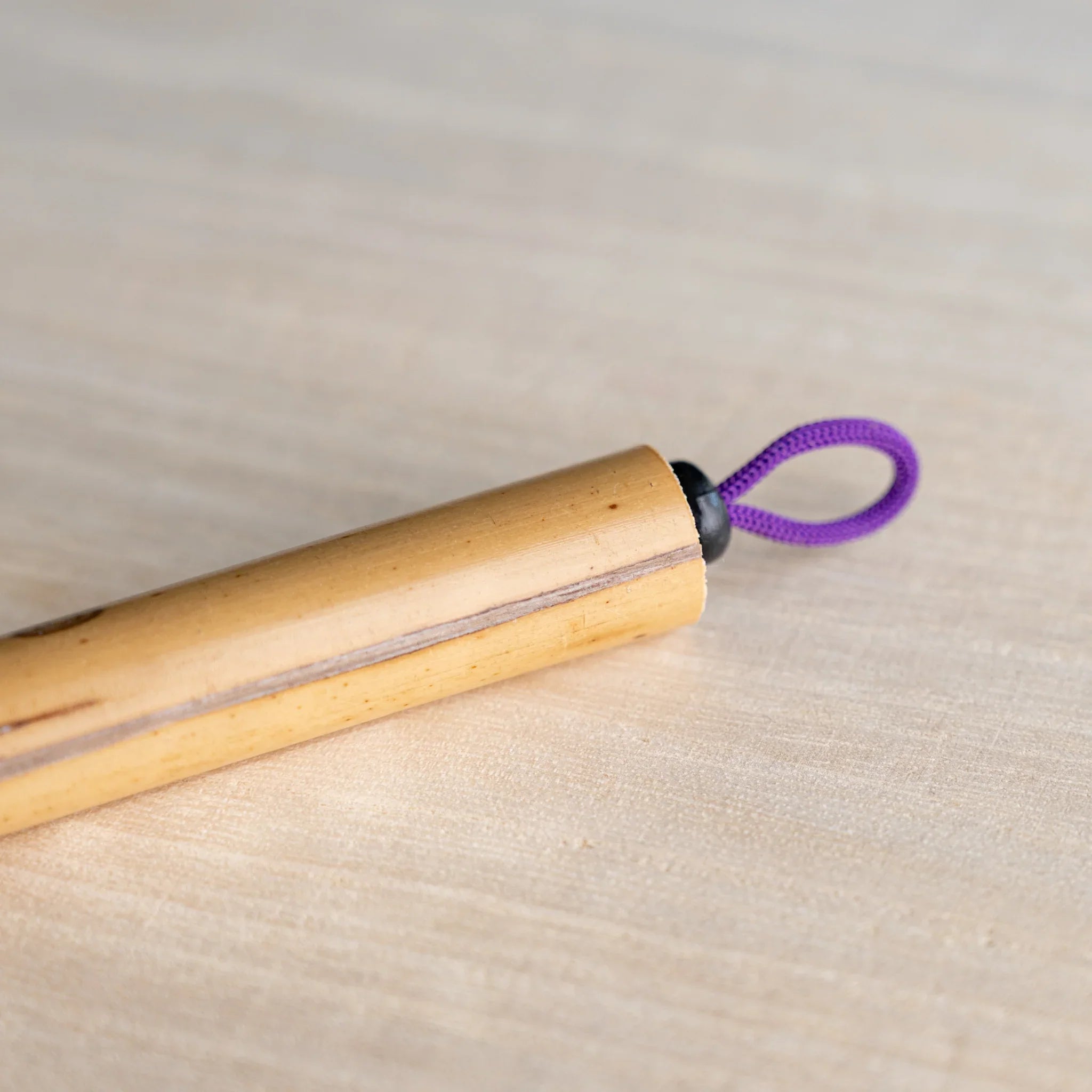 Close-up of Boku-Undo bamboo dip pen top end showing purple braided hanging loop fastened with black bead