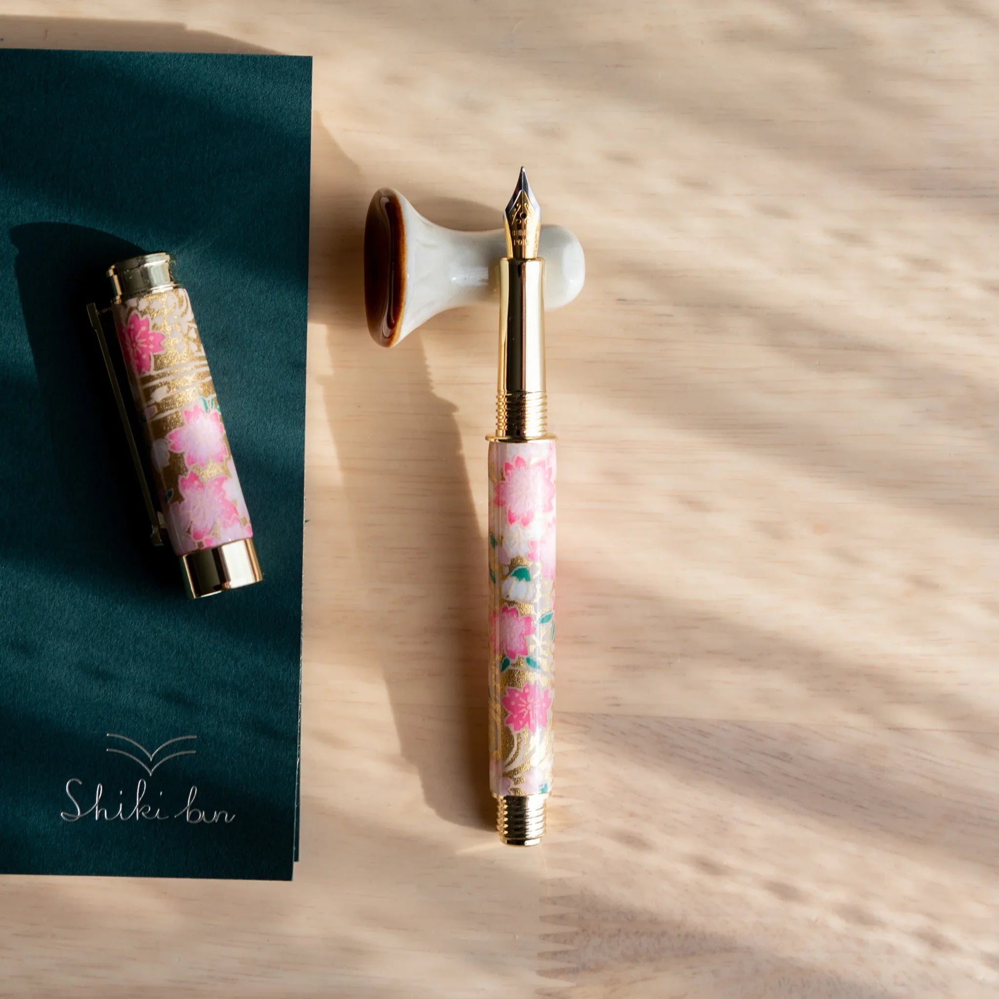 Close-up view of brown mushroom handcrafted ceramic pen rest showing detailed glaze and handmade craftsmanship