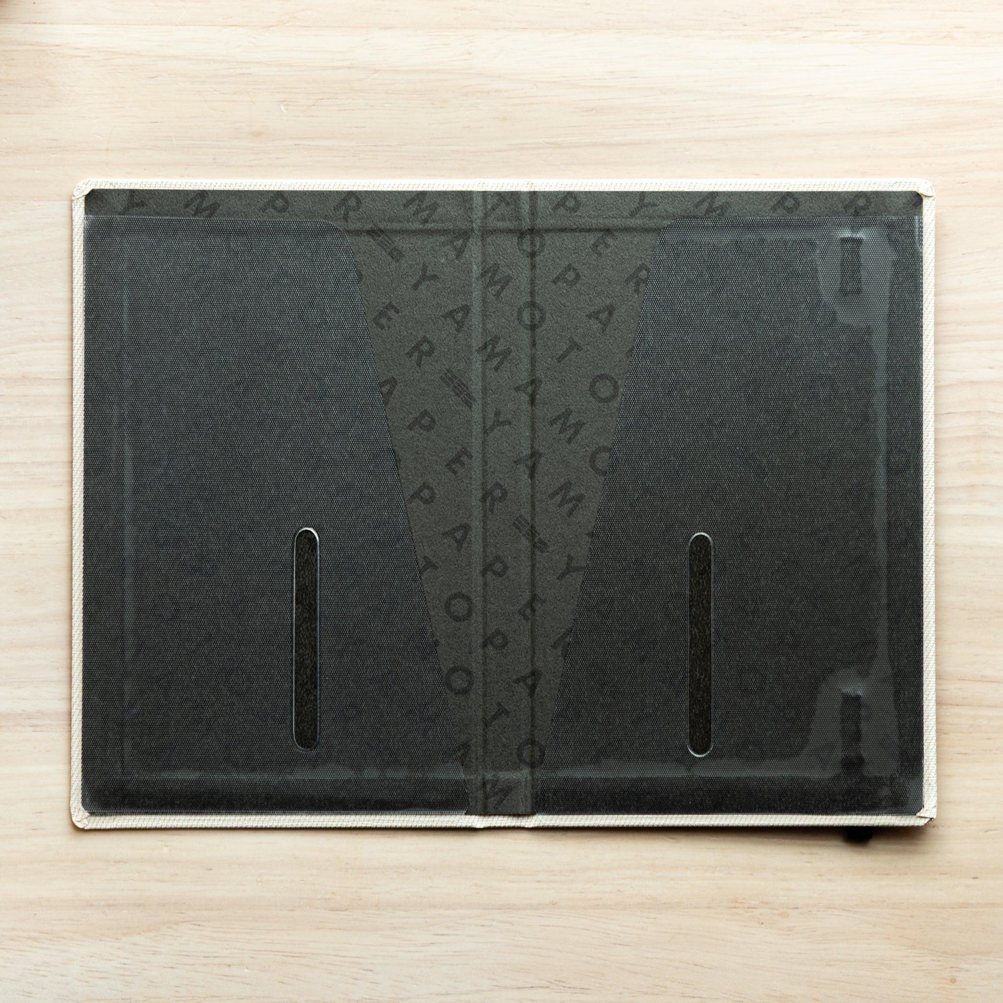 Bullet Jotter ivory white cover fully open, interior clear pocket with two vertical slots over Yamamoto Paper lining