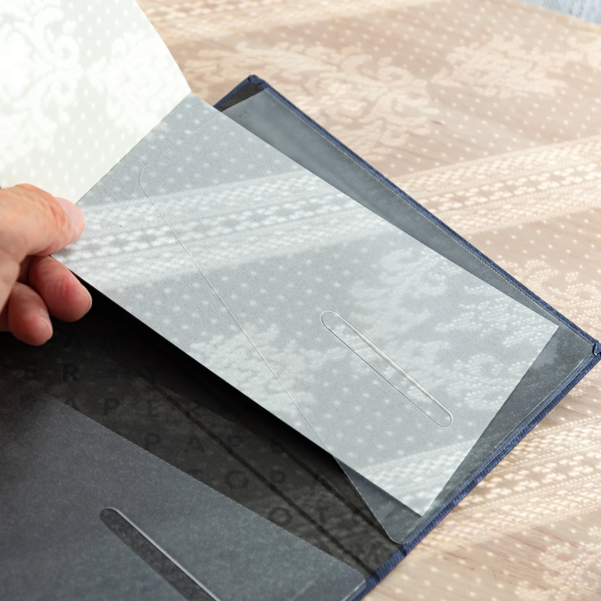 Hand opening Bullet Jotter royal blue cover to show interior clear pocket with vertical slot, royal blue fabric edging